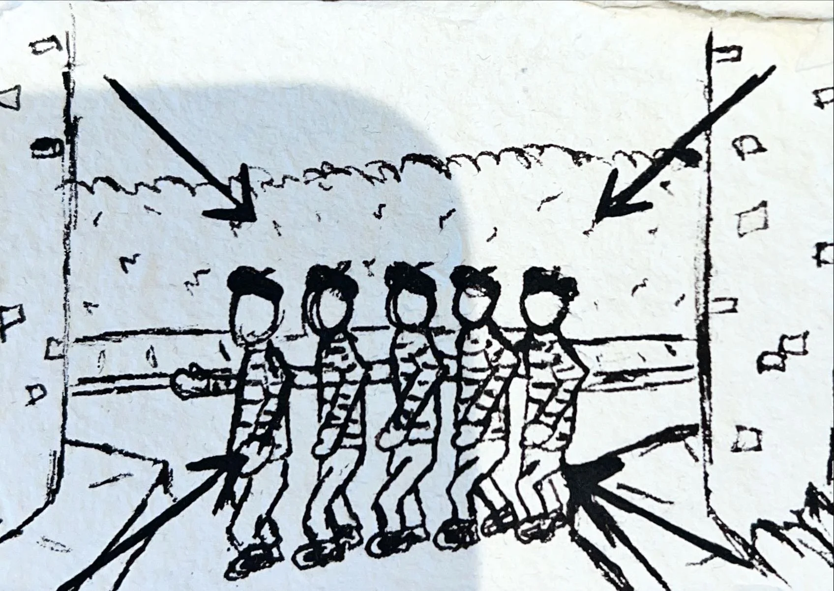 A hand-drawn sketch of five children roller skating in a line inside a skating rink, with a view of the watch and guard rails, and markings on the floor.