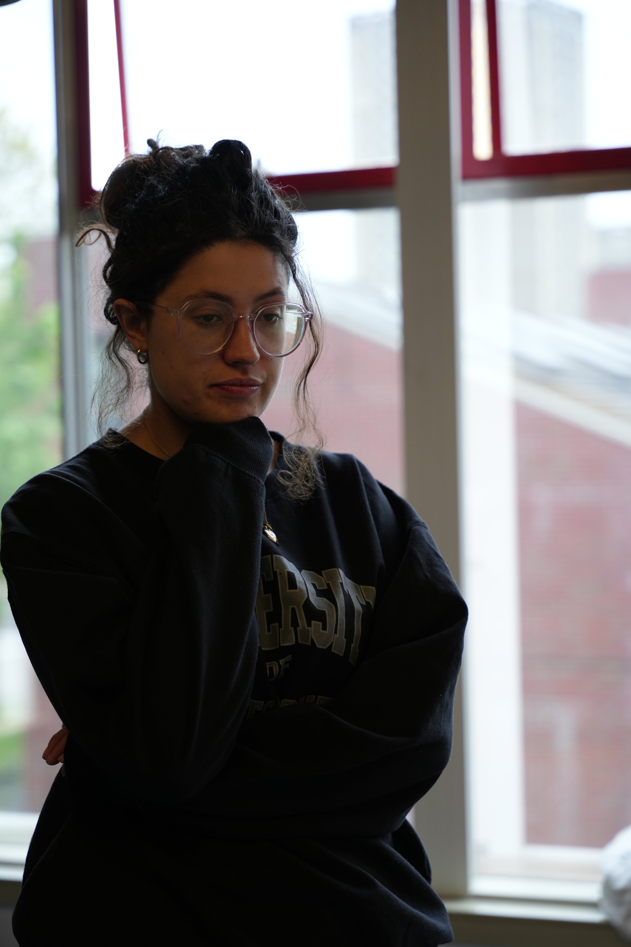 Rebecca standing, clearly pondering a decision