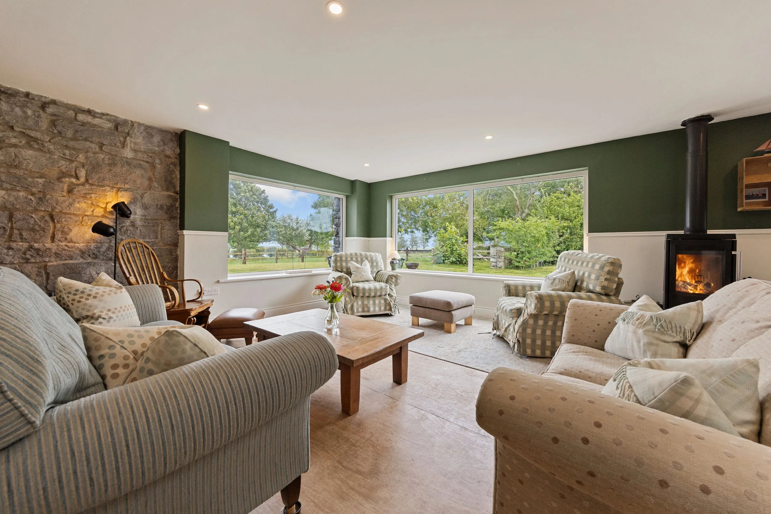 THE HEART OF THE HOUSE
Big sofas, a roaring fire and the garden just outside — a room made for putting your feet up and staying a while.