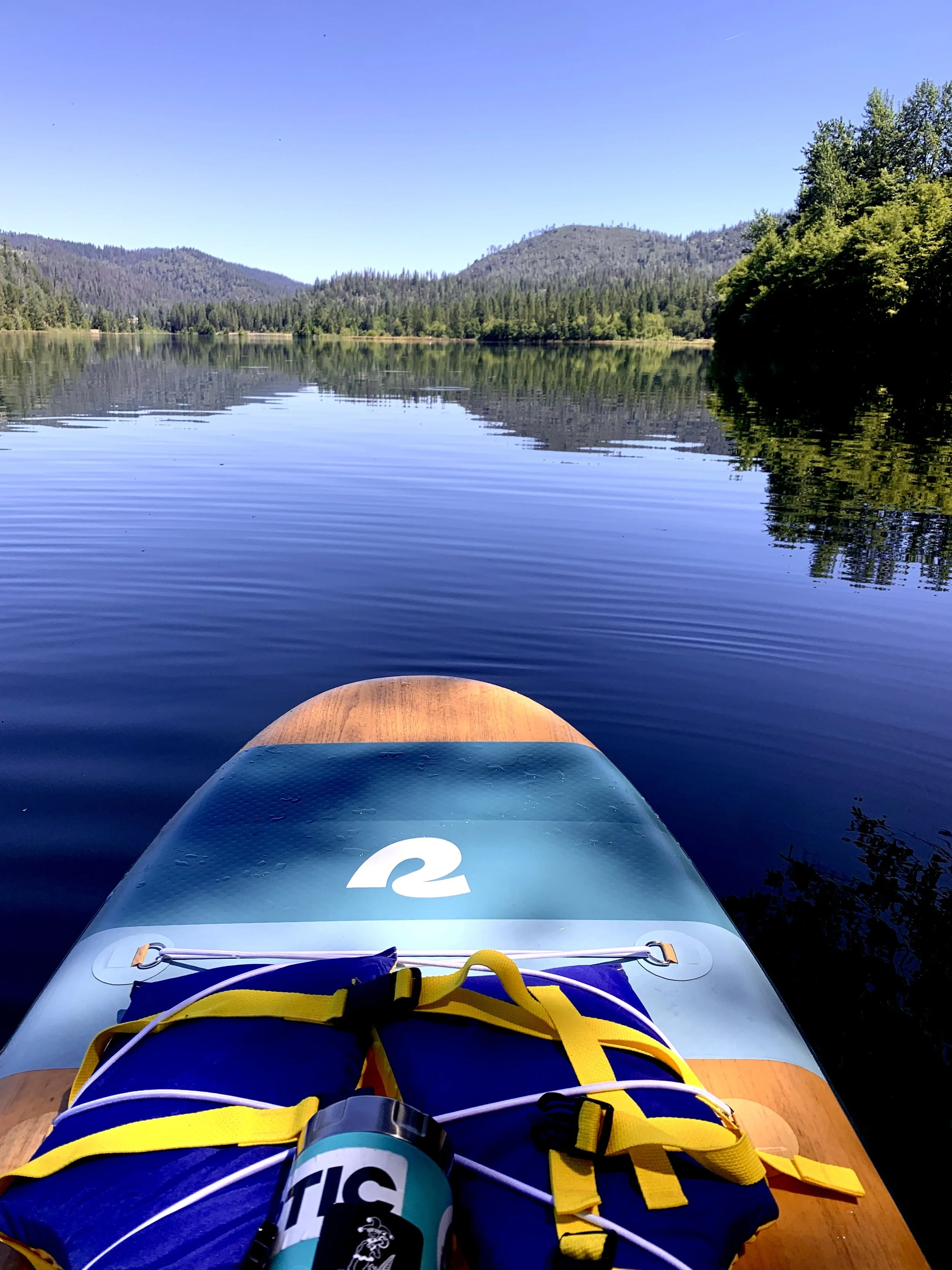 Lakeside SUP moments where movement becomes meditation & conversation becomes connection
