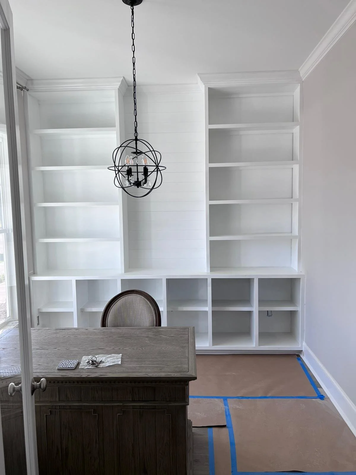 Custom built-in designed and crafted to bring both style and functionality to this office space.