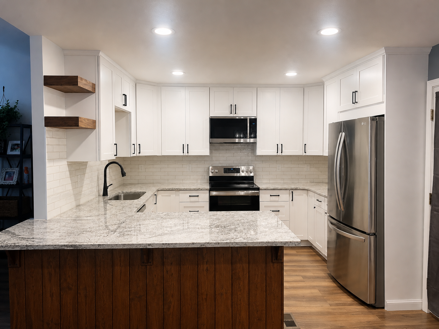 This kitchen renovation features a bright, modern layout with full-height white shaker cabinets, quartz countertops, and a classic subway tile backsplash. The space is anchored by a large island with a warm wood accent, creating a nice contrast and a