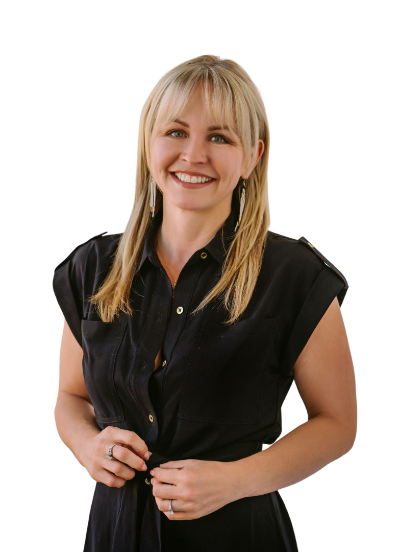 A woman with blonde hair wearing a black dress, smiling, against a studio background.