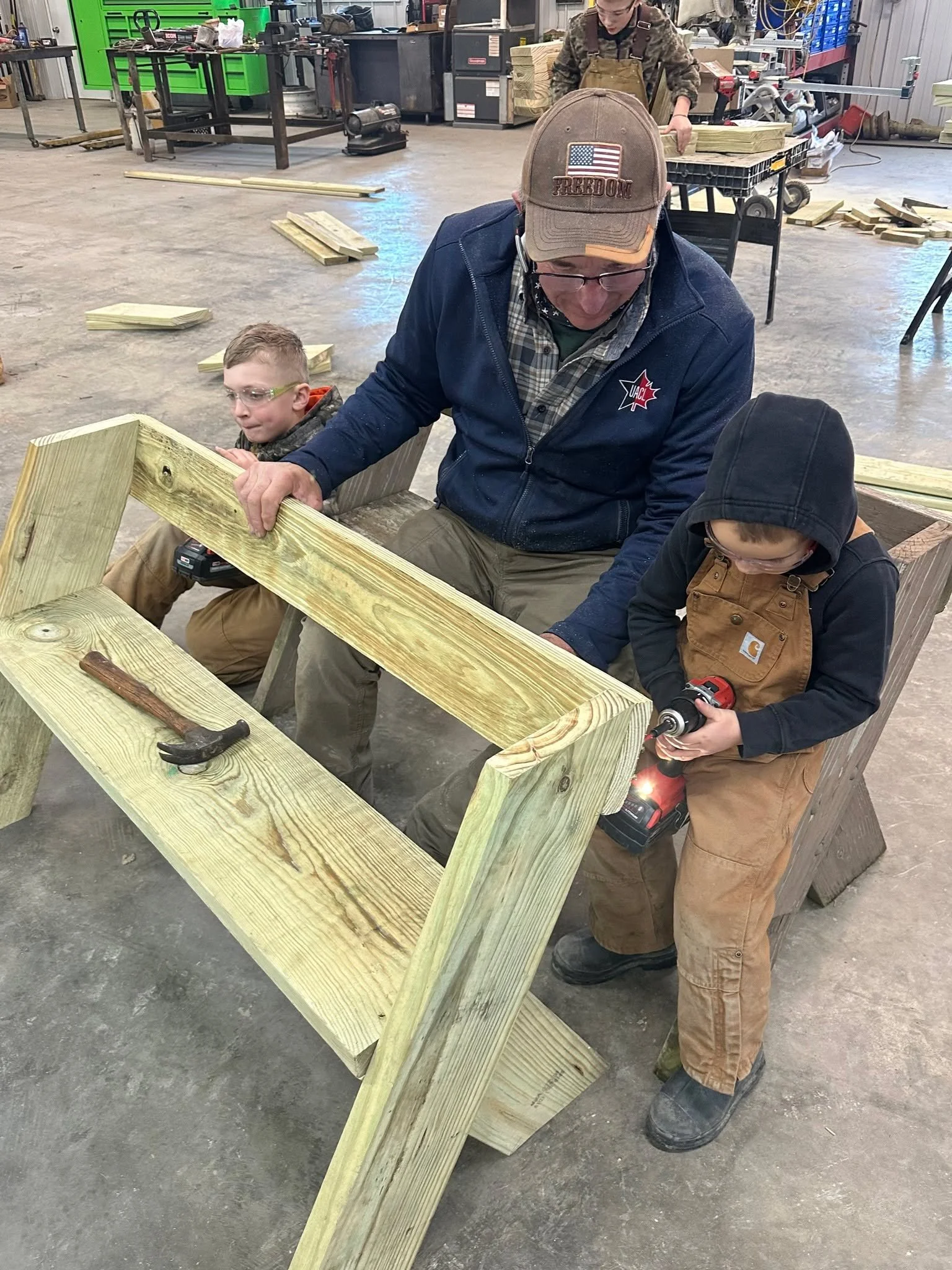 On a cold Saturday morning in late January, four generations of the Knowles family constructed Aldo Leopold benches which will be donated to Giving Gardens locations in Colchester and Macomb. Pictured are Marion and Kendall Knowles, Roman Yard (10), 