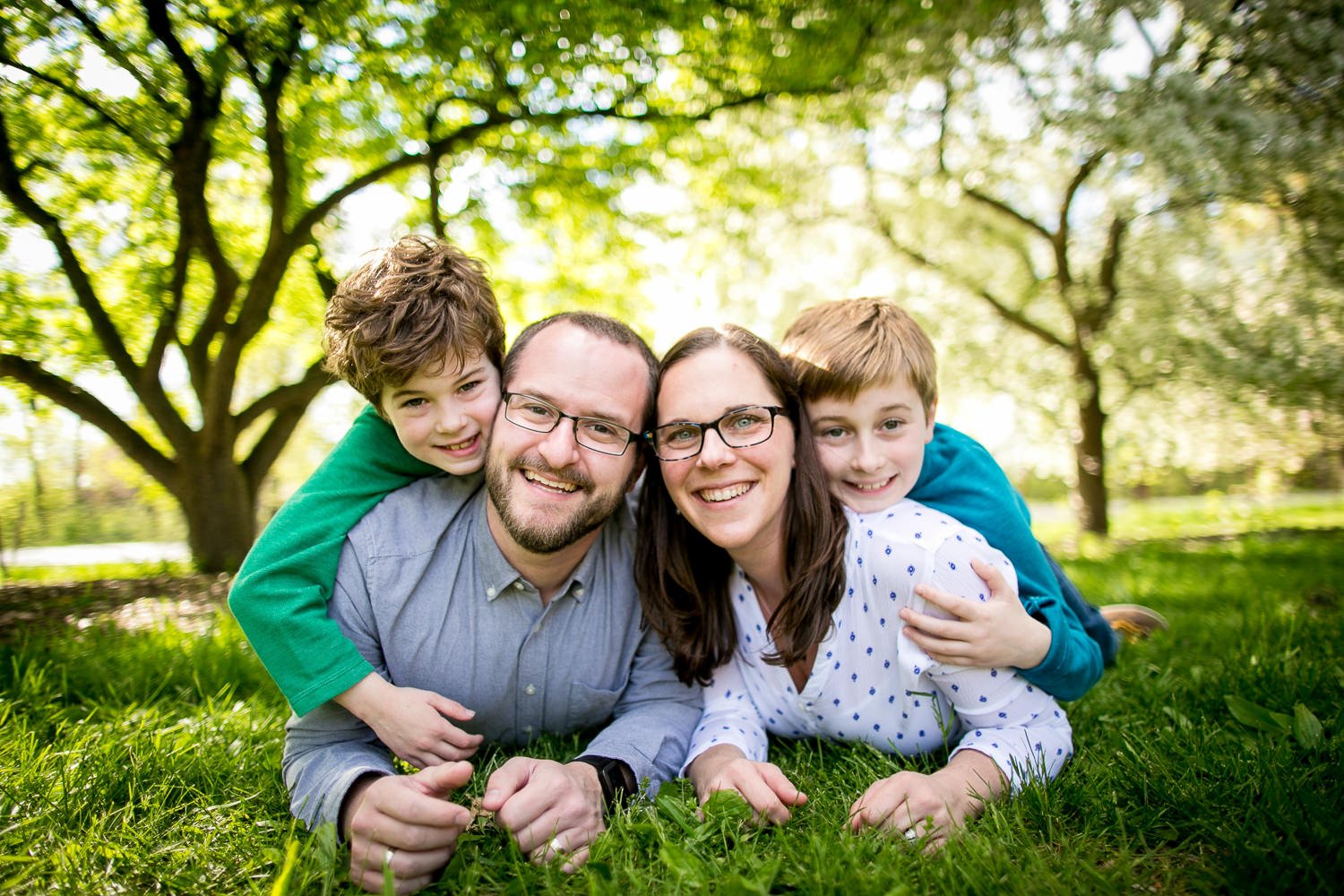 Family photography, Family photographer, professional, best of madison Outdoor Family Portrait in Madison, Wisconsin – A smiling family poses together in nature, maureen cassidy photography, best of madison, relaxed, LBGTQIA friendly, family photos t