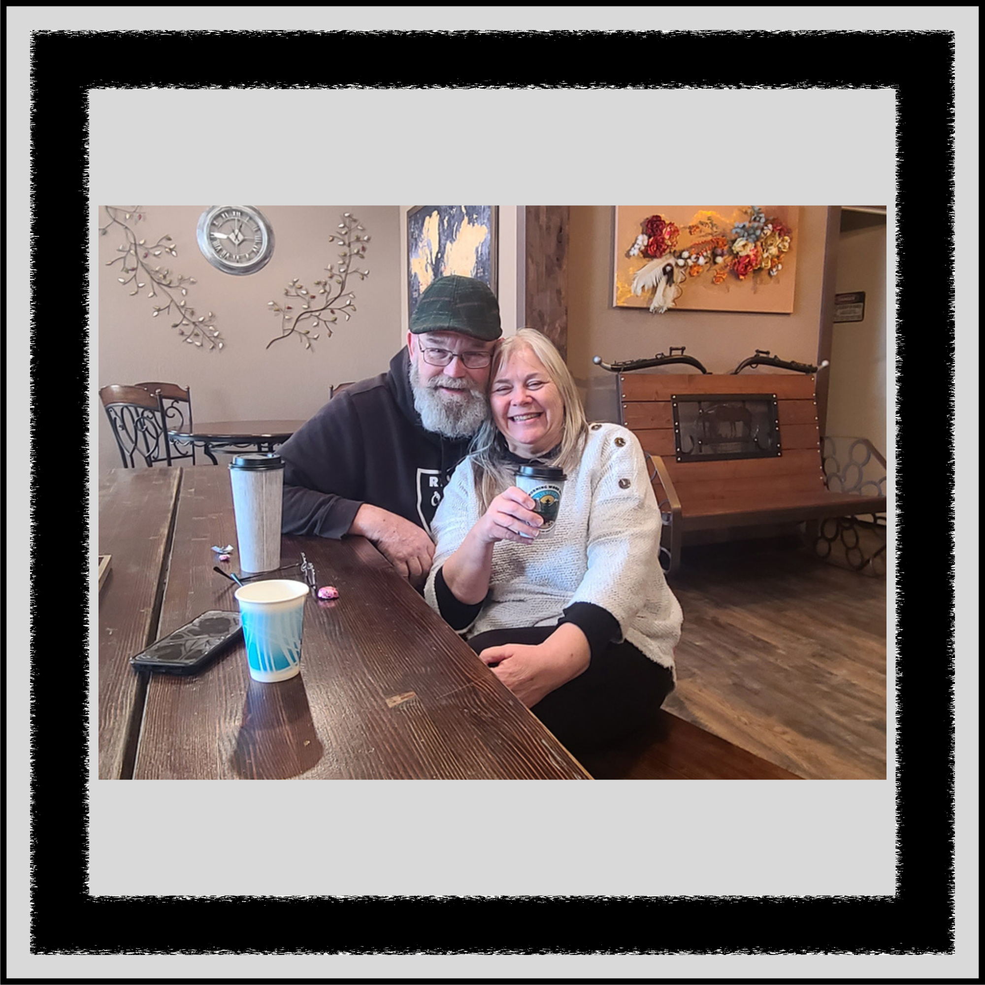 Customers smiling and enjoying coffee together inside Morning Wood Brew