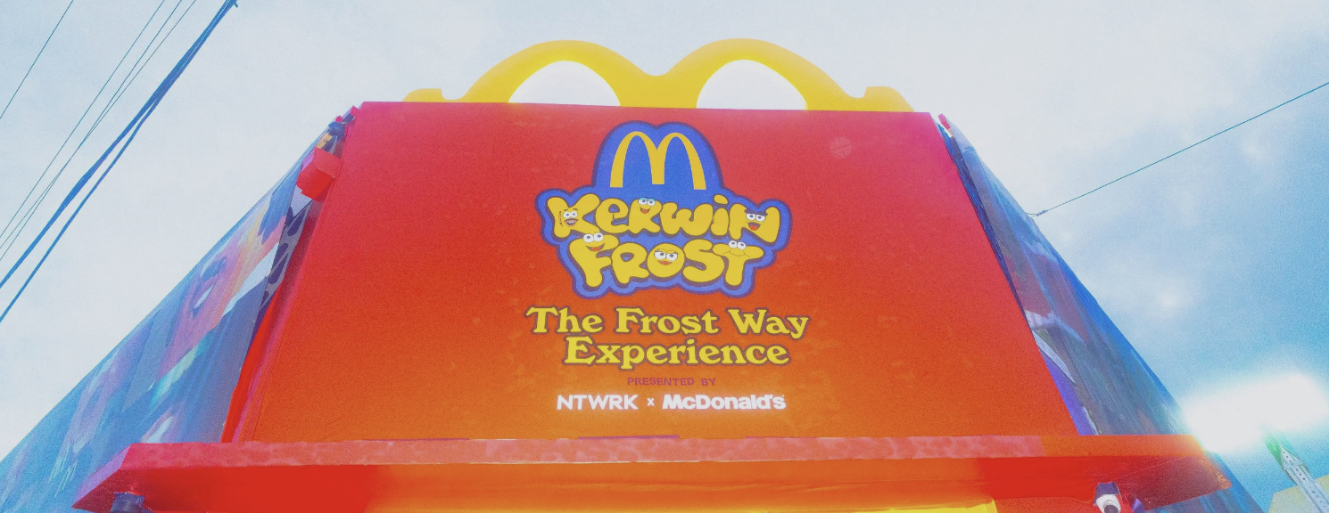 A large McDonald's advertisement sign promoting 'Sesame Frost,' titled 'The Frost Way Experience,' presented by NWTRK and McDonald's, with a blue sky background and power lines.
