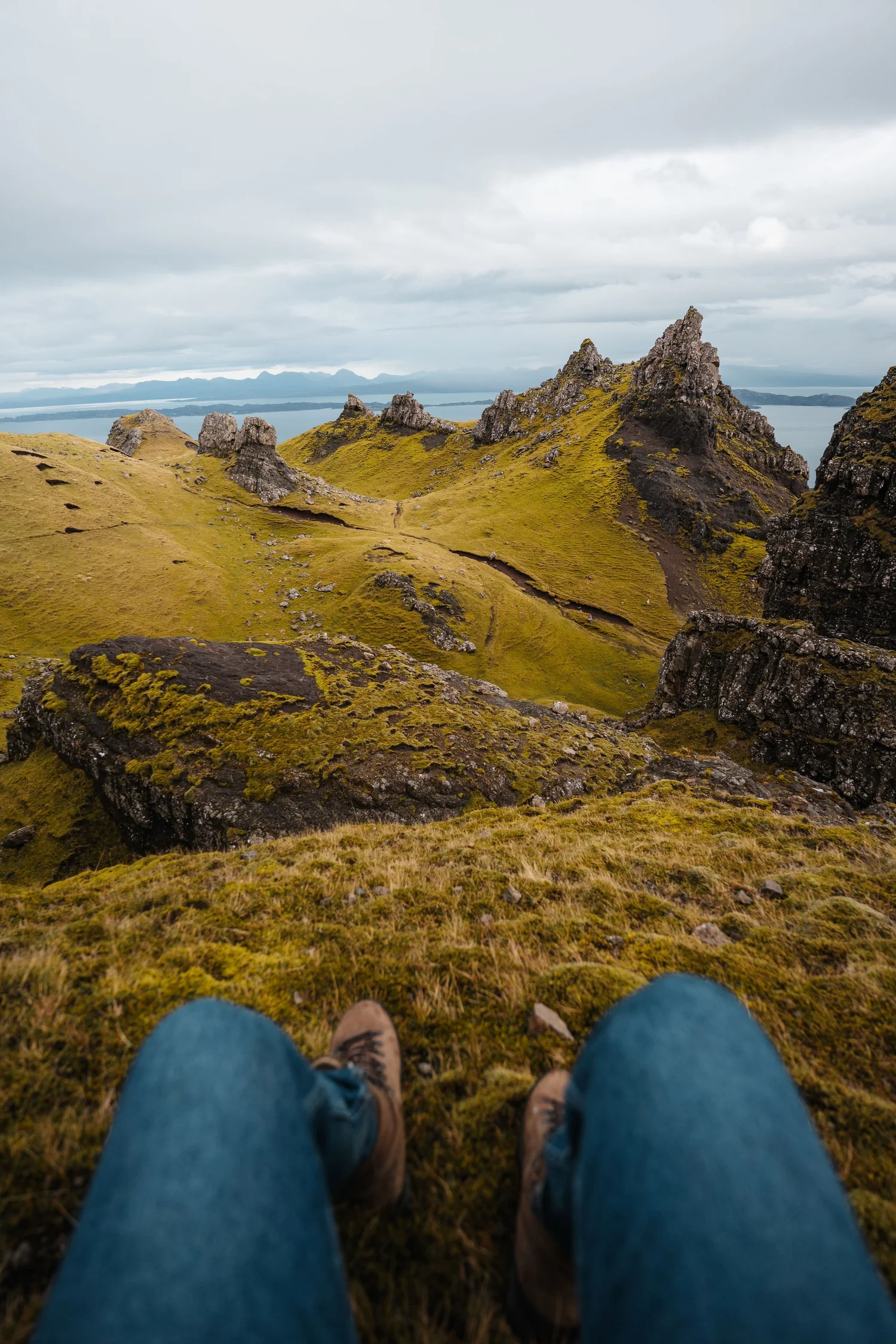 A traveller sitting above a rugged Scottish landscape