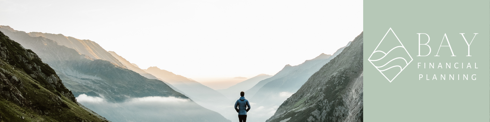 A person standing in a mountain valley facing a misty horizon during sunrise or sunset, with a green and white logo in the upper right corner for Bay Financial Planning.