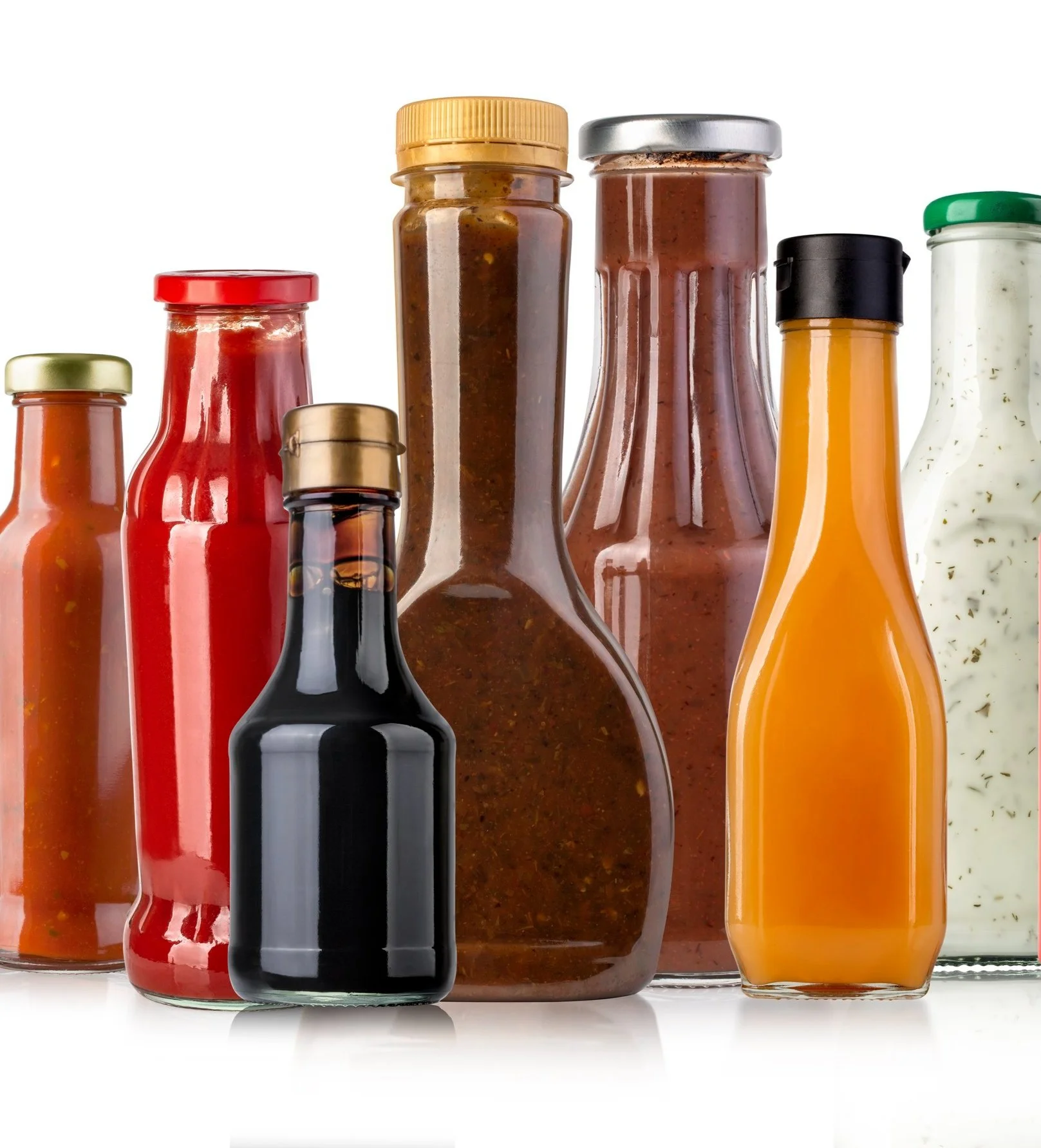 Various condiment bottles including ketchup, soy sauce, and salad dressing, displayed upright against a white background.