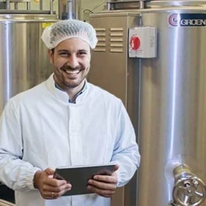Man in food processing facility with tablet