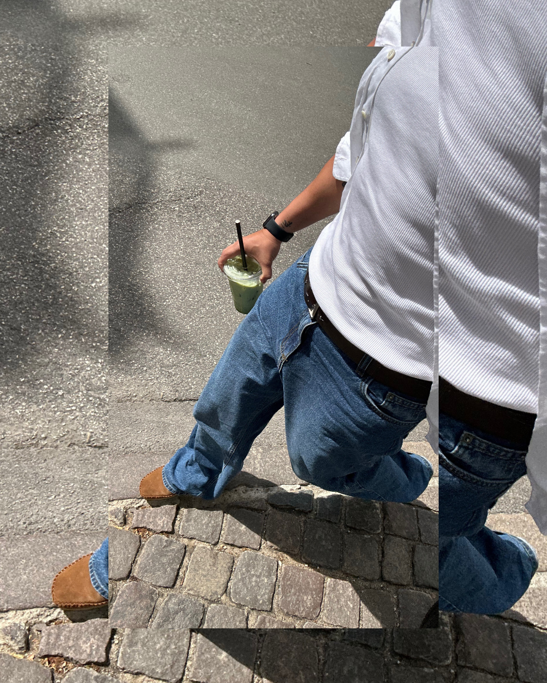 Close-up of a man wearing a high-quality white ribbed t-shirt tucked into blue jeans, showcasing a clean athletic fit and modern men's street style.