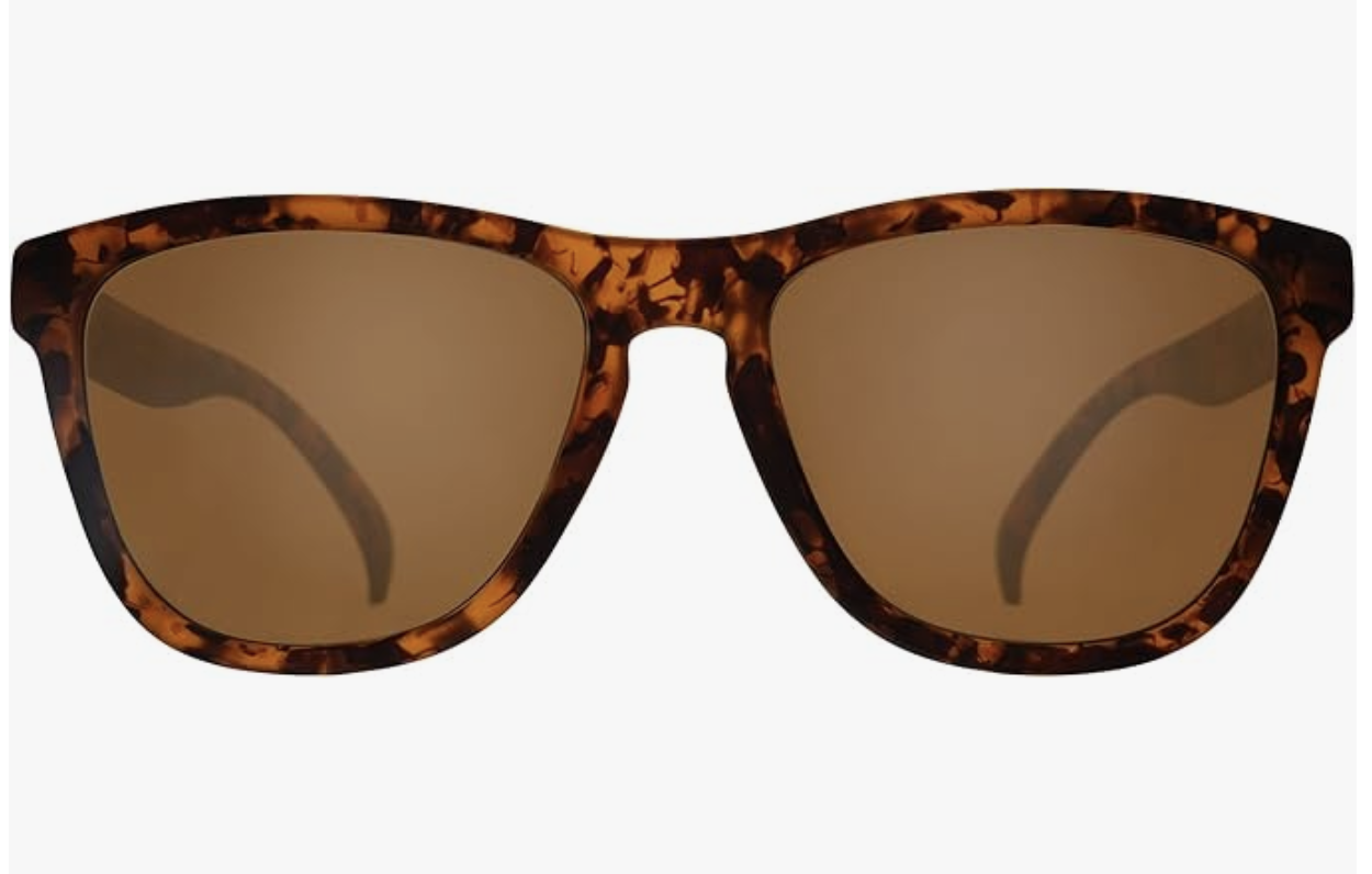 A close-up studio shot of Goodr OG Running Sunglasses featuring a classic brown tortoiseshell frame paired with polarized amber-tinted lenses.