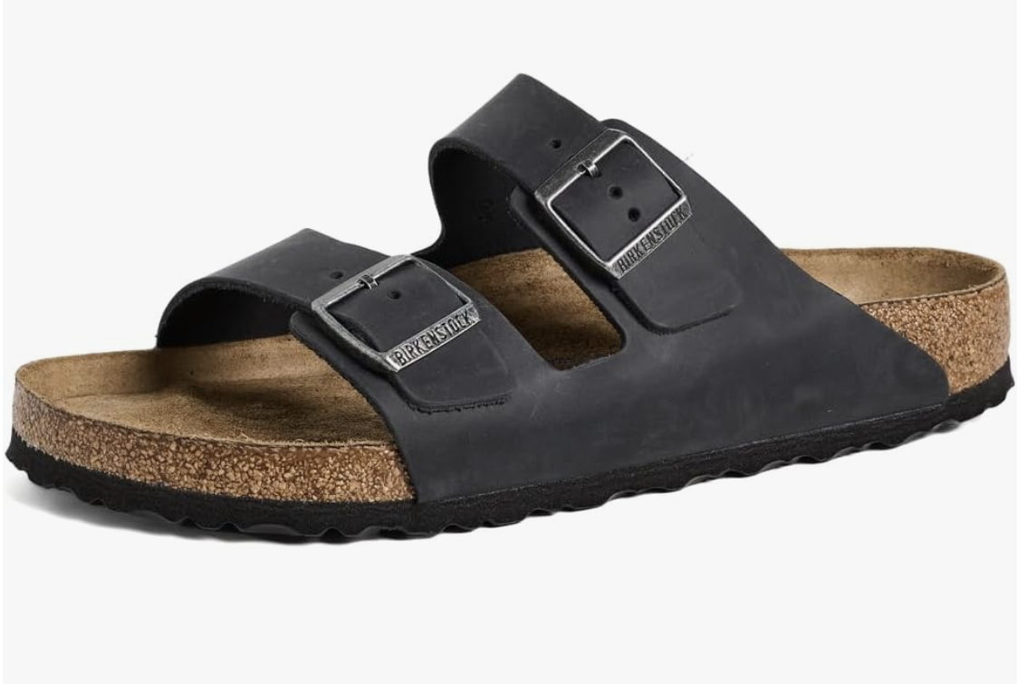 "A pair of navy blue Nike Michigan Wolverines Calm Slides 2.0 for men, featuring a contoured foam design and the yellow Michigan ‘M’ logo on the strap."