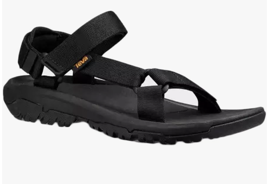 A pair of black Teva Hurricane XLT2 sandals for men, featuring adjustable webbing straps and a rugged Durabrasion rubber outsole for hiking and travel."