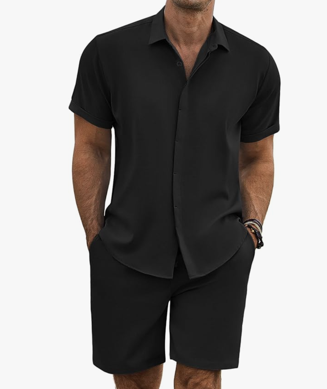 A man wearing a coordinated black short-sleeve camp collar shirt and matching linen shorts, representing a modern men's summer matching set for 2026.