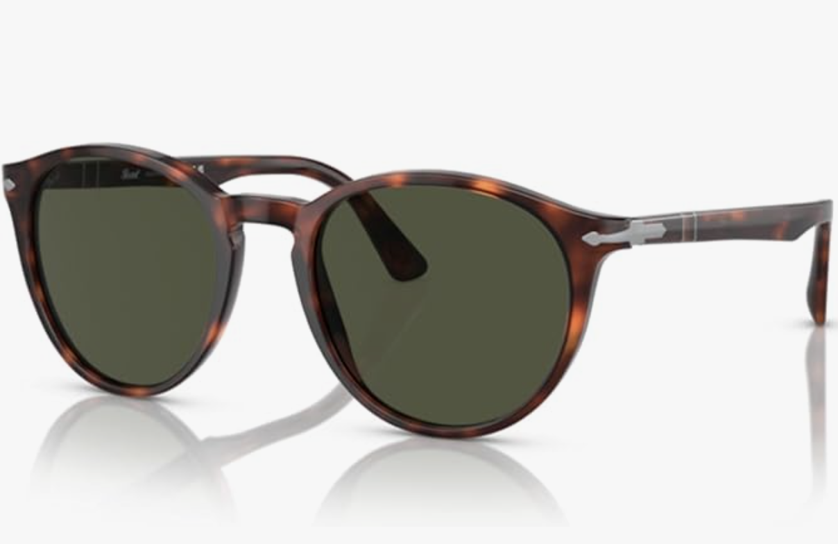 A close-up studio shot of Persol PO3152S round-frame sunglasses featuring a rich brown tortoiseshell acetate frame, dark green lenses, and the signature silver arrow hinges on the temples.