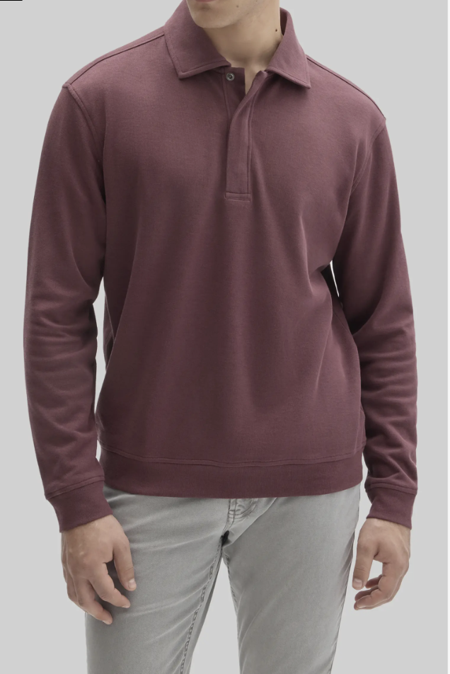 Man wearing the Robert Barakett Peakstone Long-Sleeve Cotton Polo in burgundy with light grey trousers.