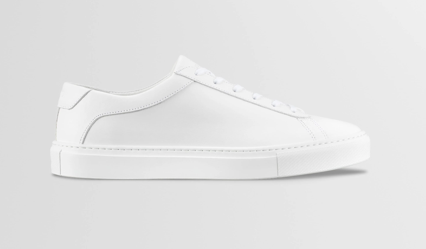 A close-up shot of a pair of all-white ON Cloud 4 running shoes, showcasing their distinctive cloud-pod cushioned sole and clean mesh upper design.