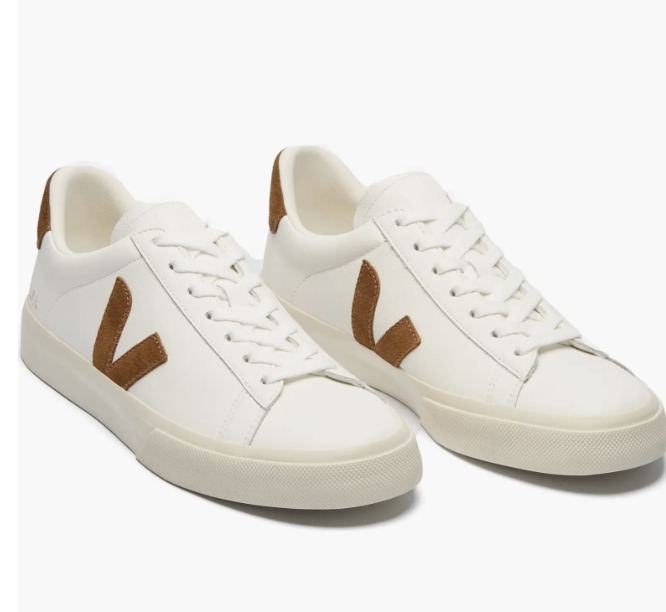 A pair of white leather Veja Esplar sneakers with tan suede "V" logos and heel tabs, representing a clean and minimal men's shoe trend for 2026.