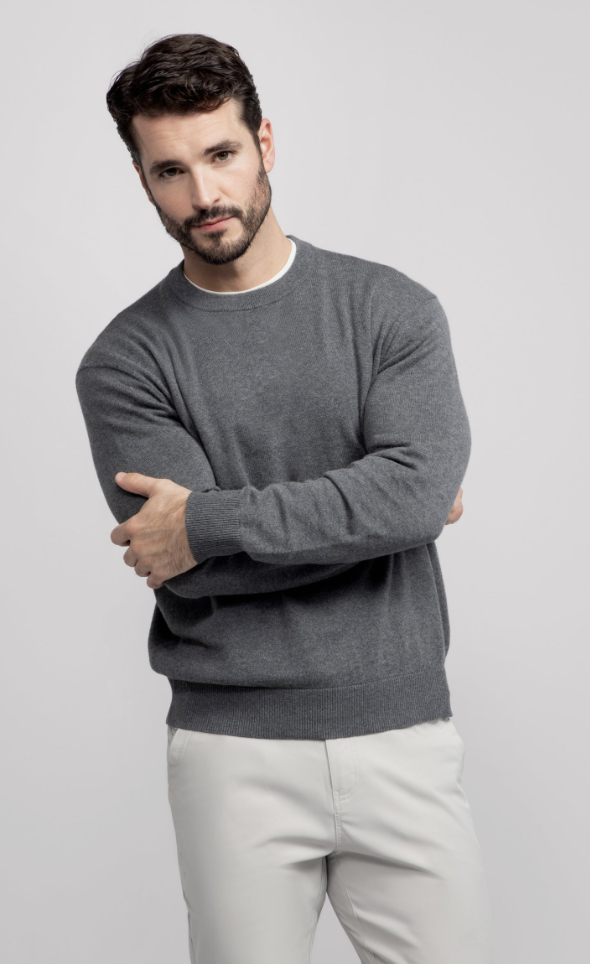 Man wearing the Jack Archer Anytime Crewneck Sweater in heather grey over a white tee.
