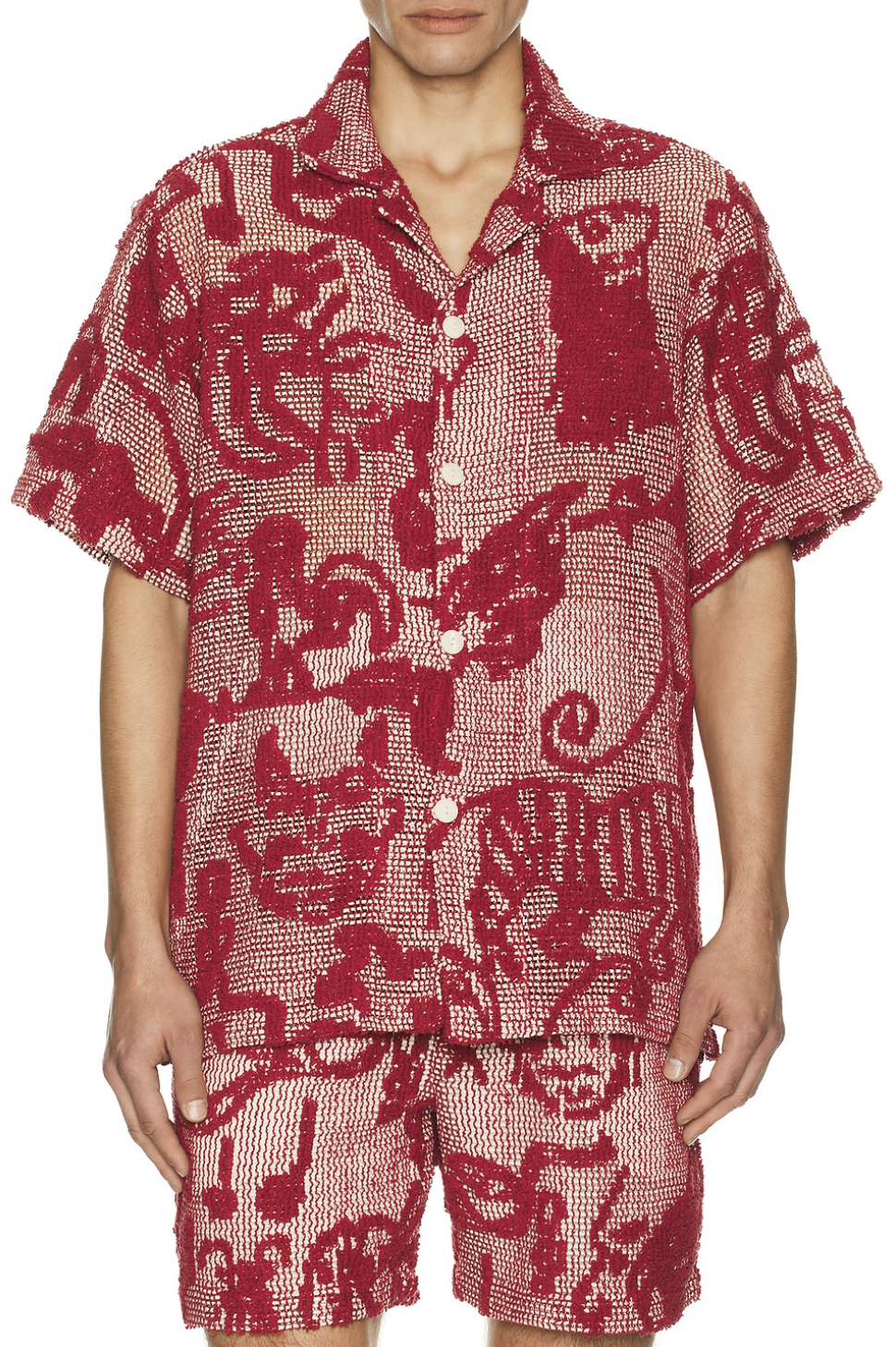 Man wearing a red and cream patterned OAS Arcano Cuba shirt in a textured knit fabric.