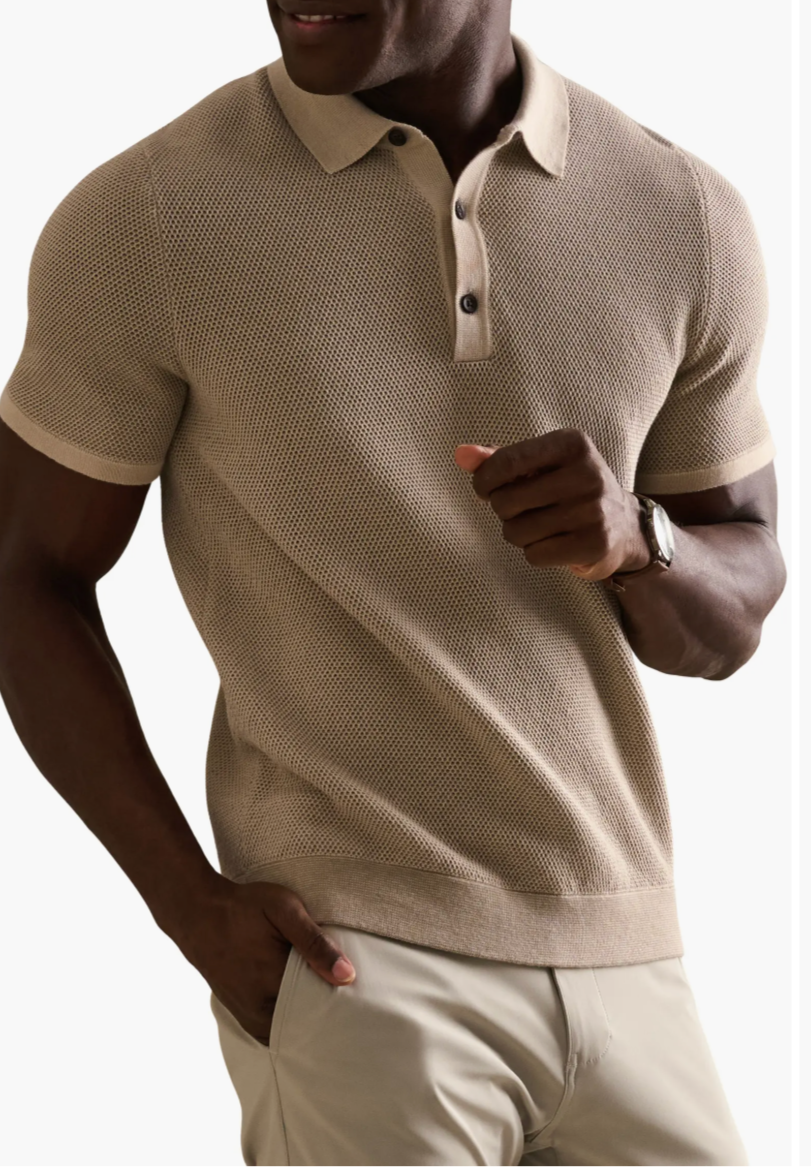 Man wearing a tan honeycomb-textured Rhone Mercer Knit Polo with ribbed collar and cuffs.