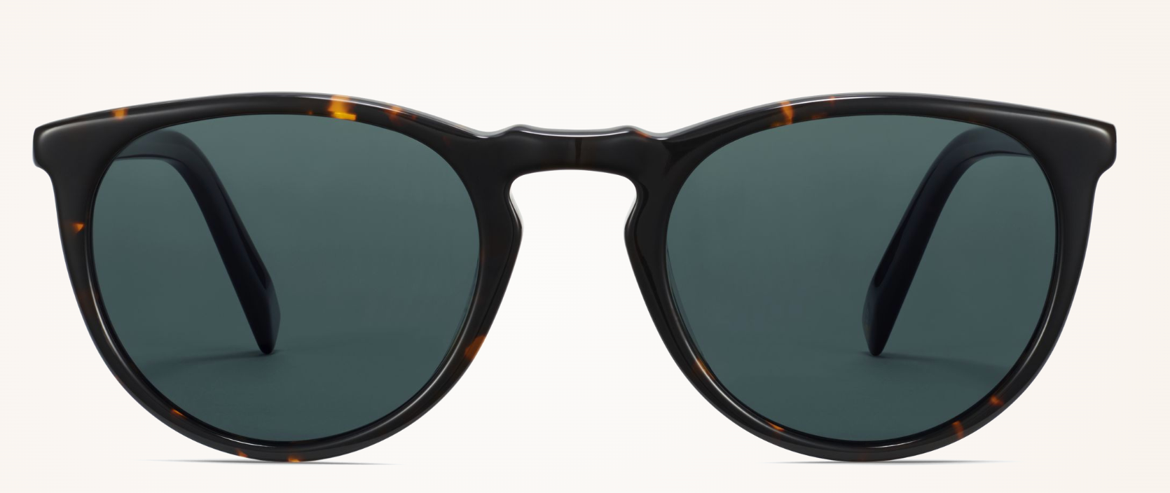 A close-up studio shot of Warby Parker Haskell round-frame sunglasses featuring a dark tortoiseshell acetate frame and solid green-grey lenses.