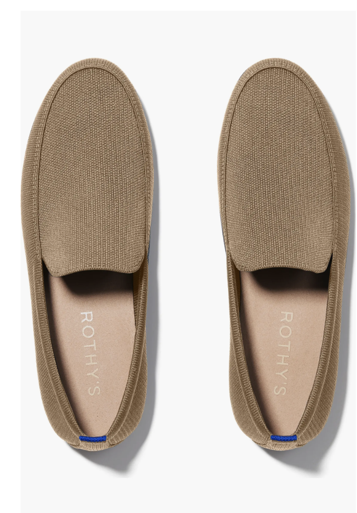 A top-down view of a pair of tan Rothy’s loafers with a blue detail on the heel, showcasing a clean and sustainable penny loafer style for 2026.