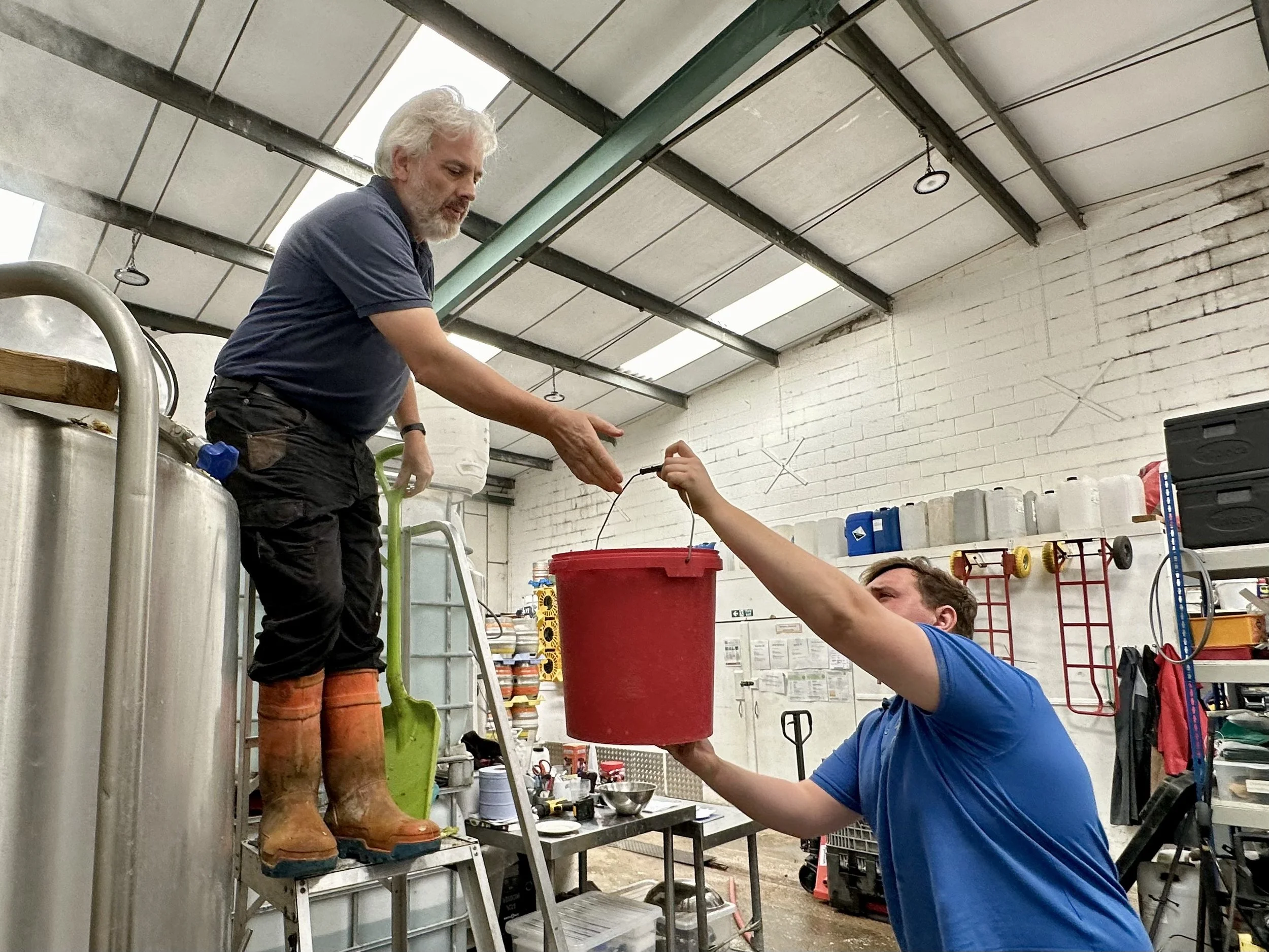 Cliff (L) and Cameron (R) putting hops into the brew one bucket at a time