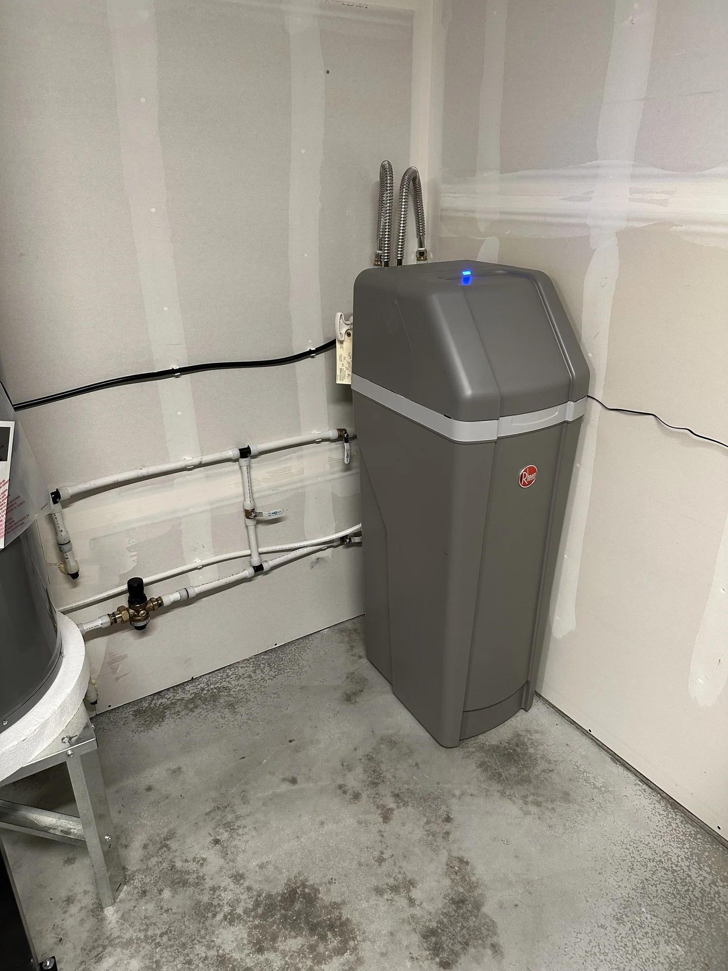 Installed water softener with its supply and bypass plumbing connections