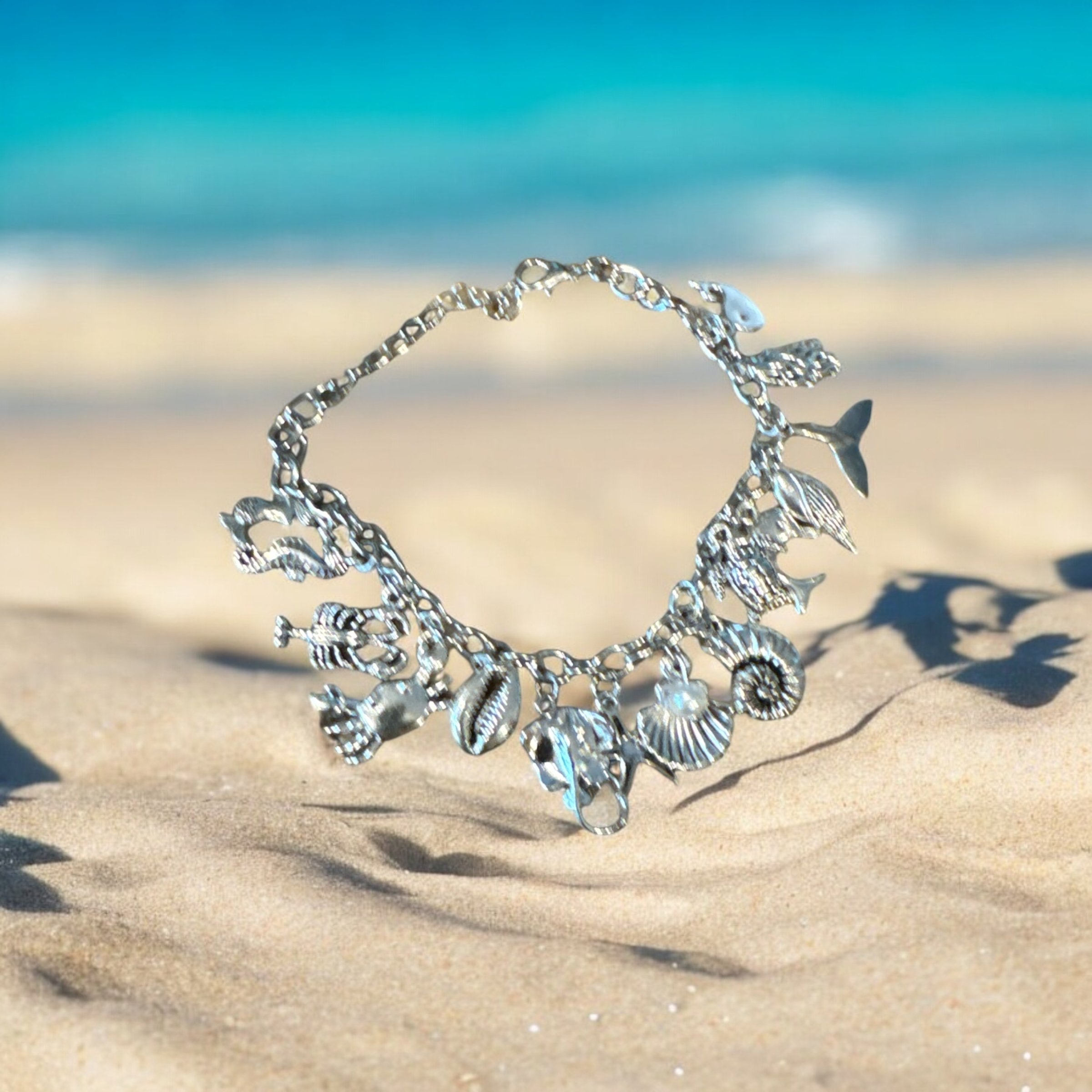 598 Charm bracelet with ocean items, whales tail, shell with pearl, mermaid, crab and more