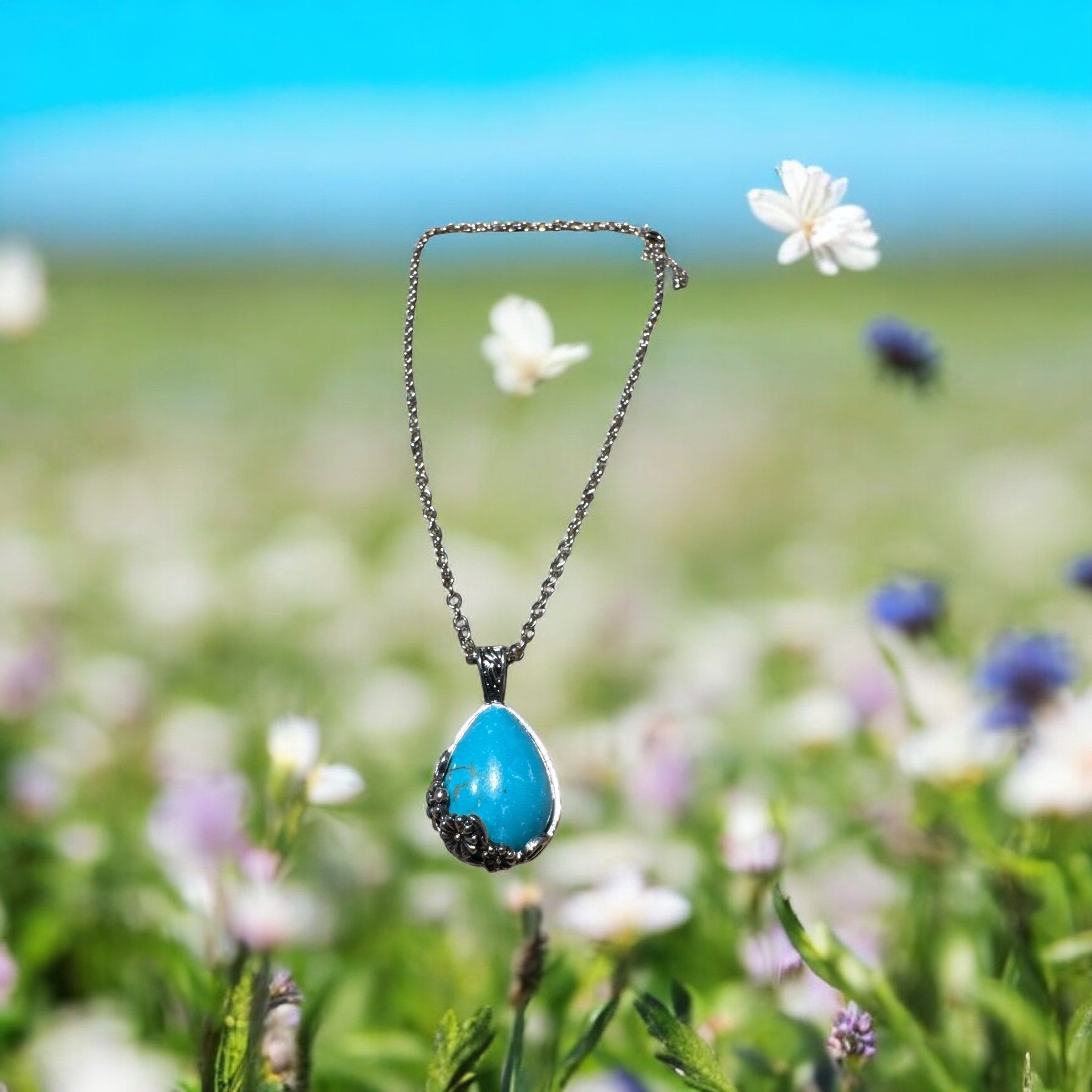 Item 633. Necklace with tear drop turquoise stone mounted with silver and flower design