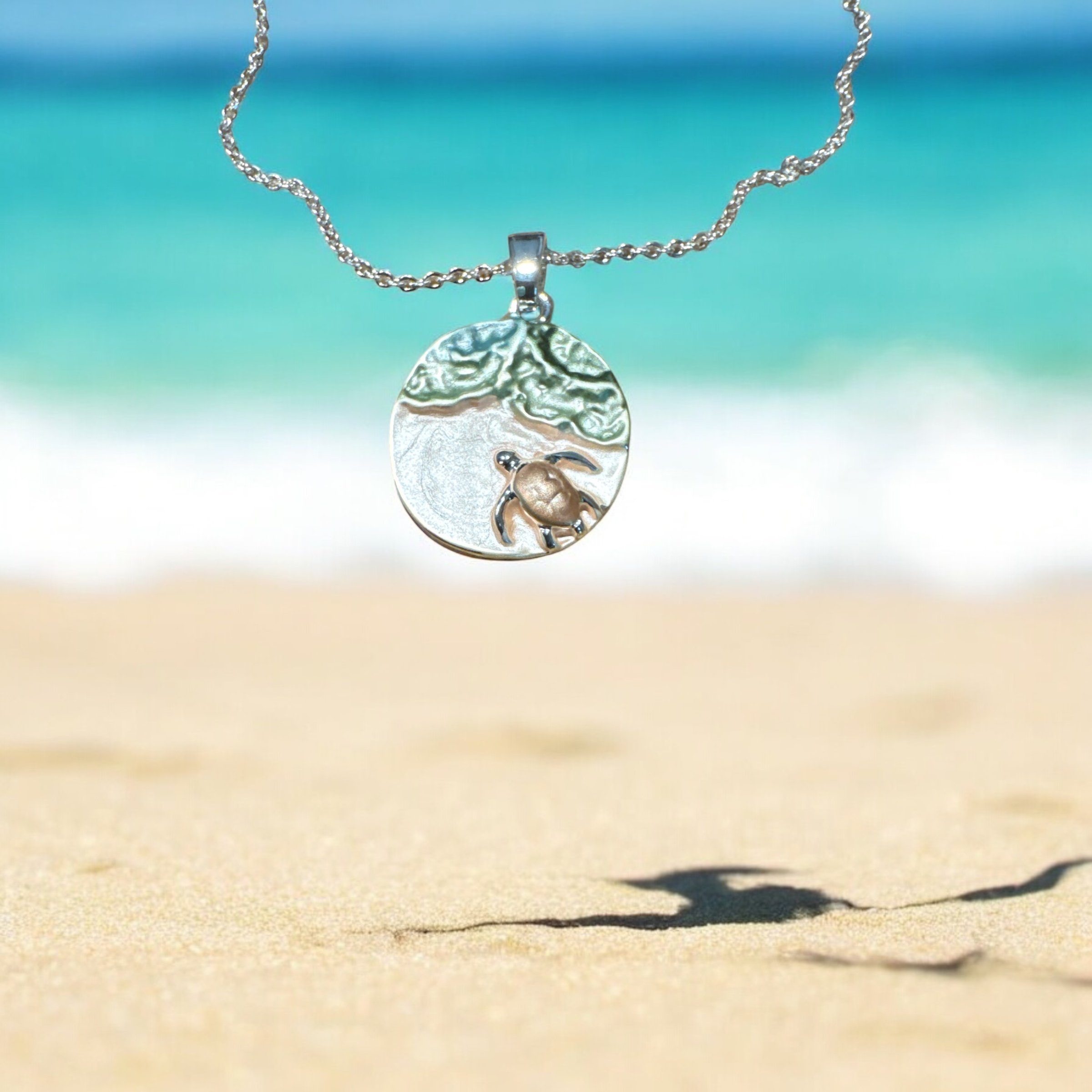 Item 638. Necklace with turtle on beach.