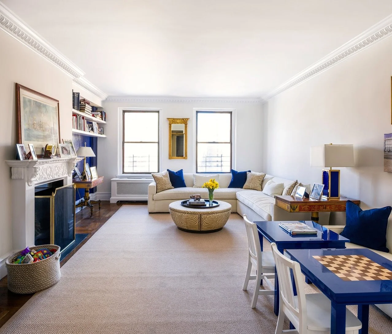 An NYC family living room with two zones, one language:

Our clients purchased a post-war 3-bedroom, 3-bath apartment with lovely ceiling height and a generous living-dining footprint. The goal was to create spaces that flex for real life for this gr
