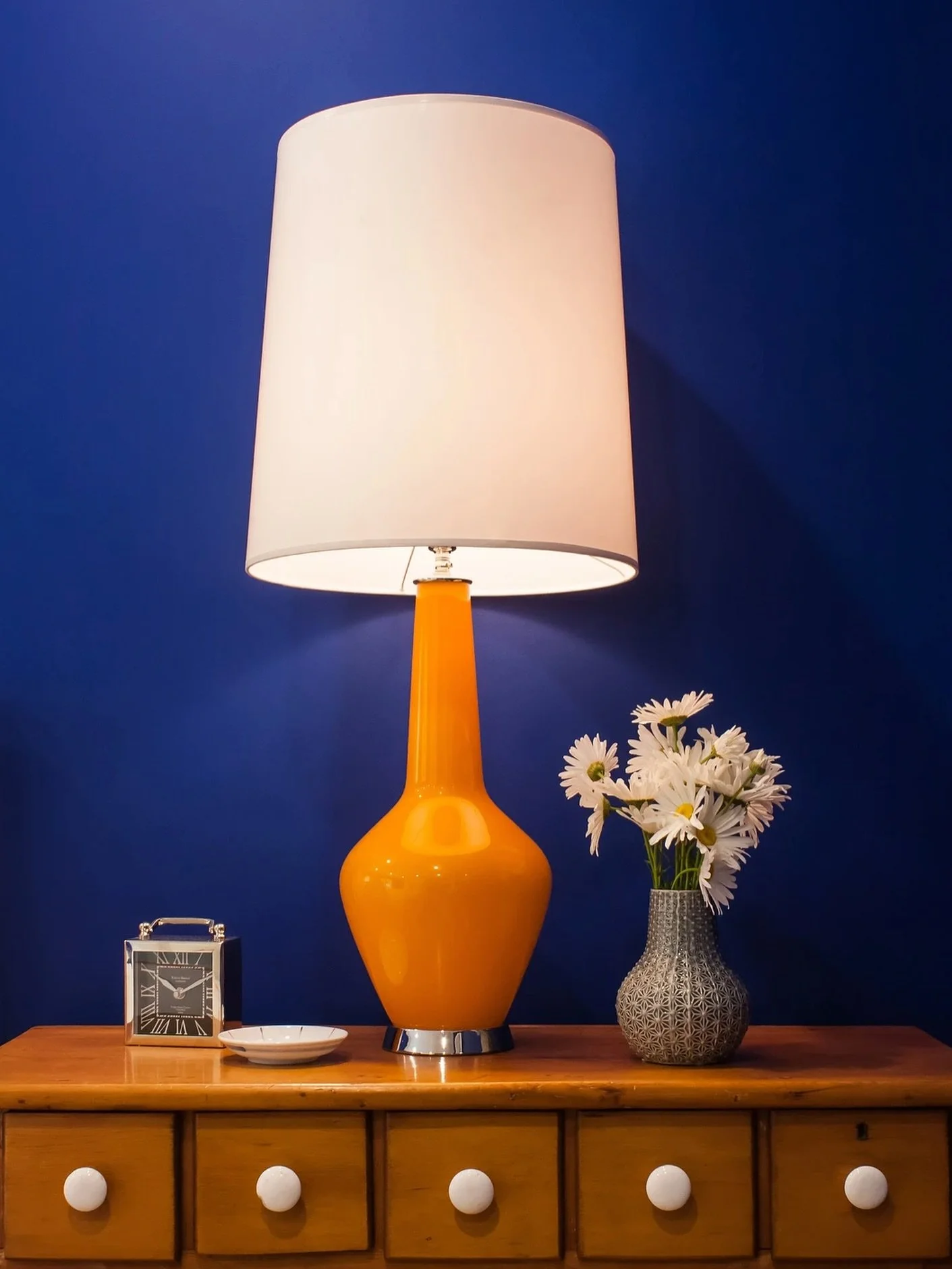 Lighting that flatters:

A sculptural ceramic lamp brings warmth and a soft pool of light&mdash;perfect for evening reading. I aim for one ambient source and one task source in every guest room; the combination feels hotel-level without feeling fussy