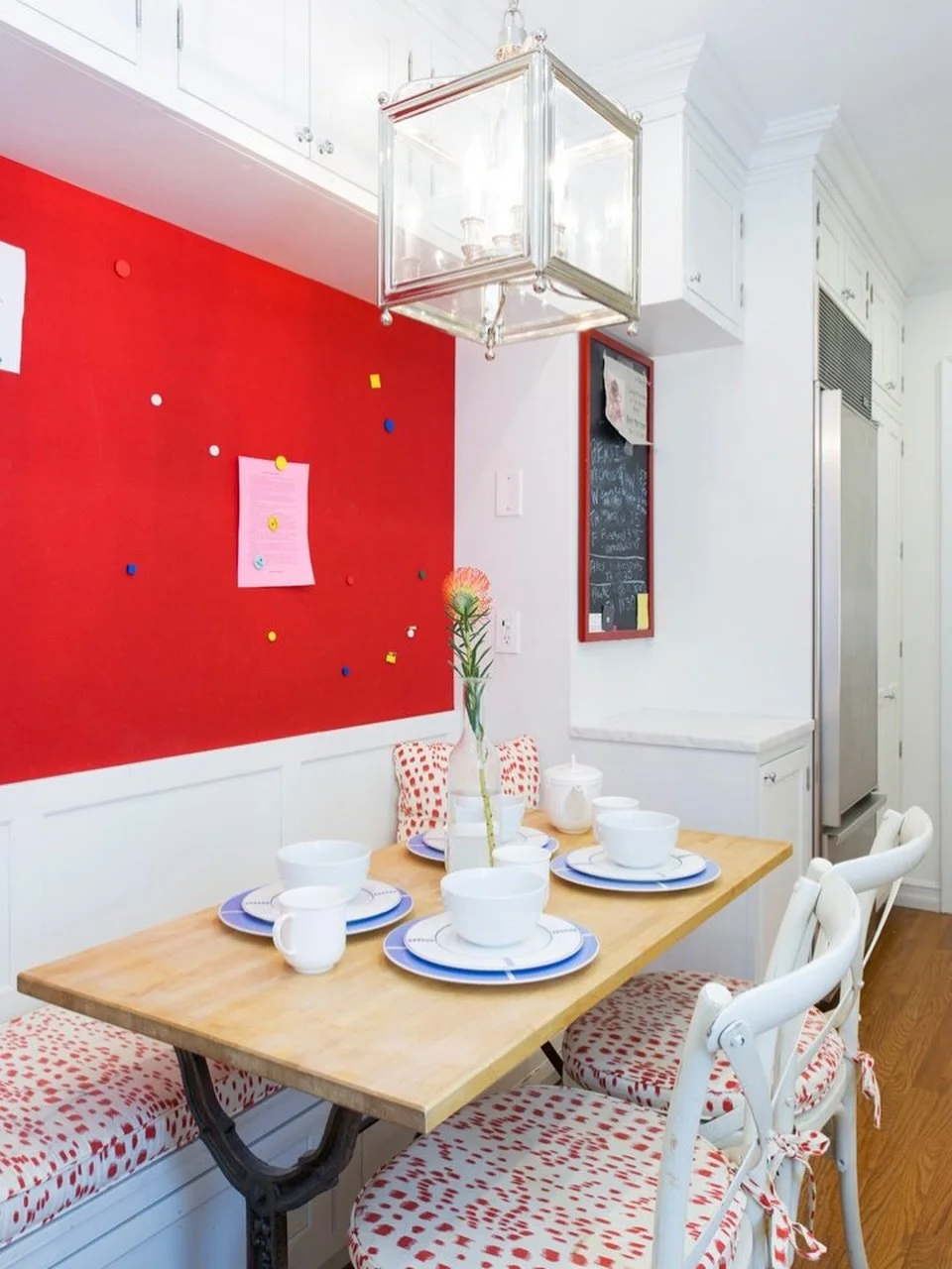 Designing for a young NYC family means balancing functionality with vibrancy (and personality!) ❤️

In this breakfast nook, a red magnetic wall (wallpaper by @loriweitzner ) creates space for an ever-evolving display of kids&rsquo; artwork, and custo