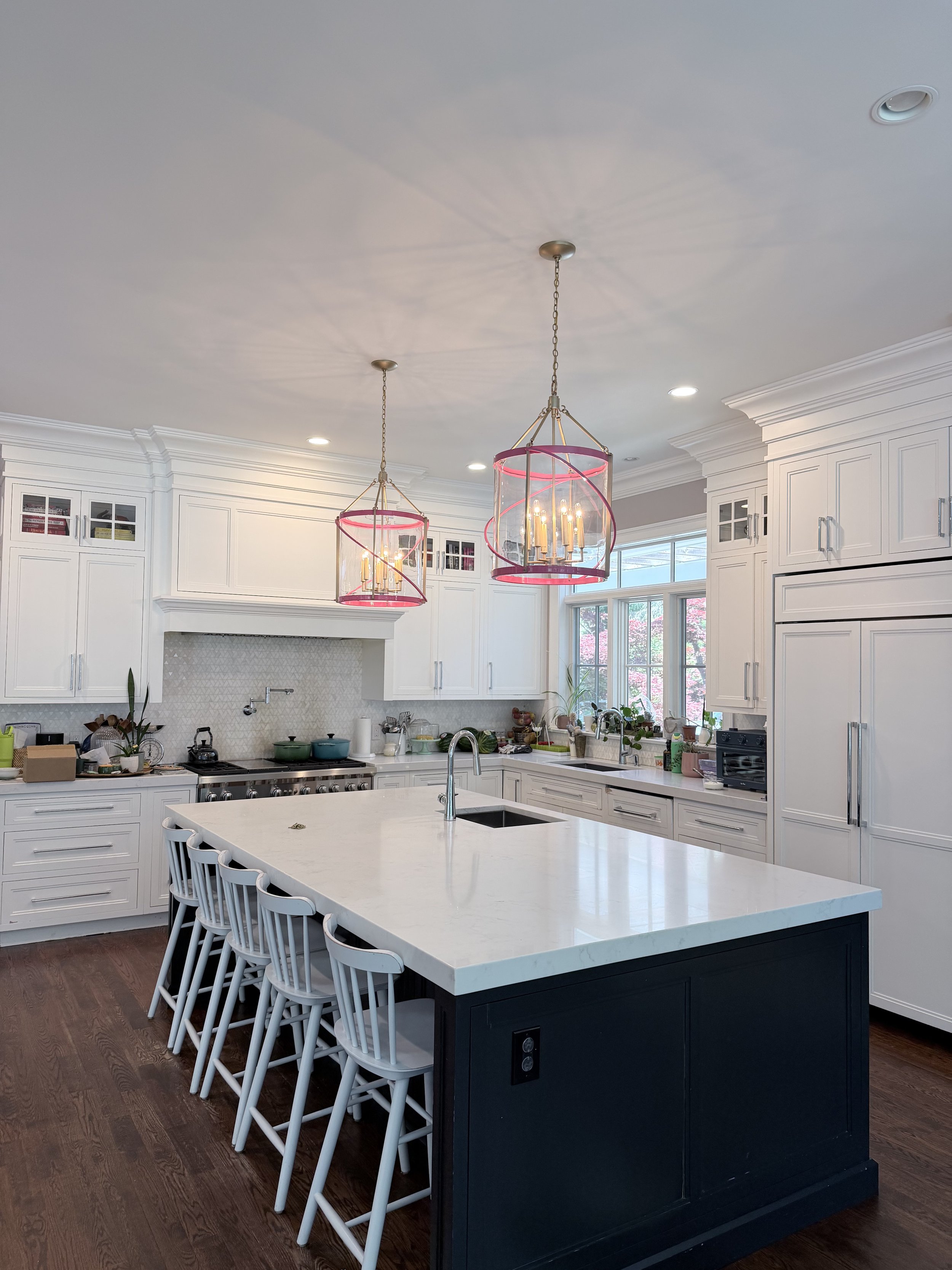 Two oversized pink pendant lights by Oomph in a Briarcliff Manor, NY kitchen, interior design by Style and Space Interiors