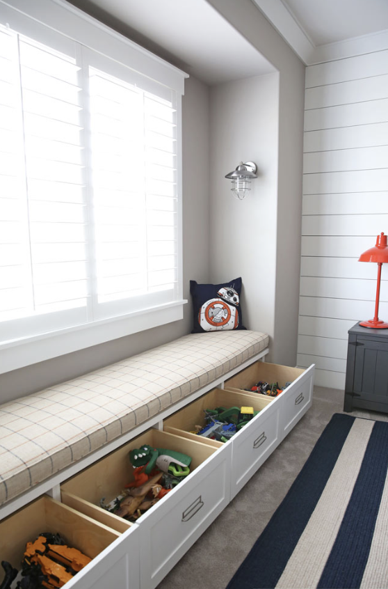 Built-in bench with drawers for storage in a multipurpose family room | Style and Space Interiors