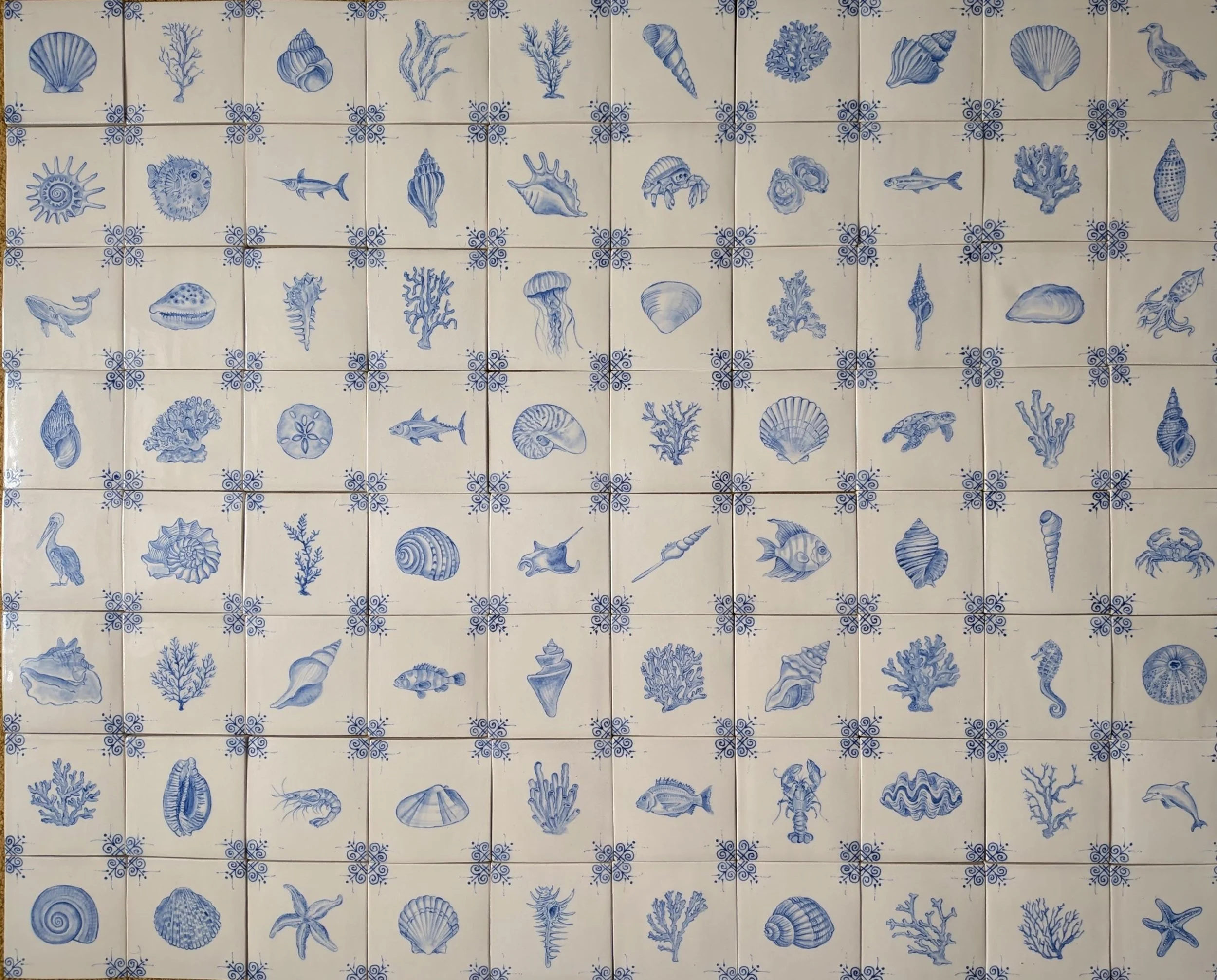 Custom coastal-inspired tiles featuring shells, sea creatures, and corals | Style and Space Interiors | Southampton New York