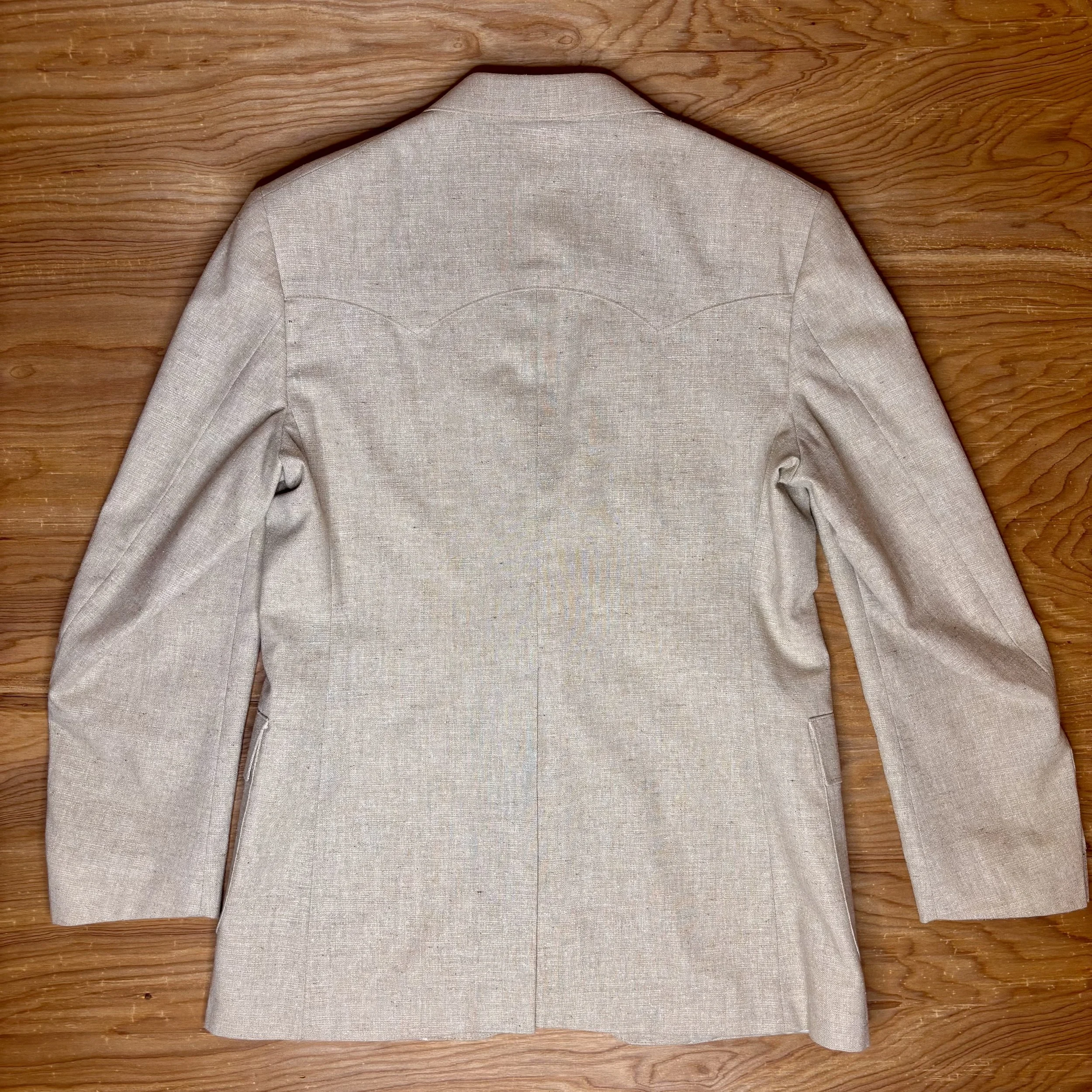 Back view highlighting subtle Western-style curved yoke detail on beige linen-blend Levi's blazer.