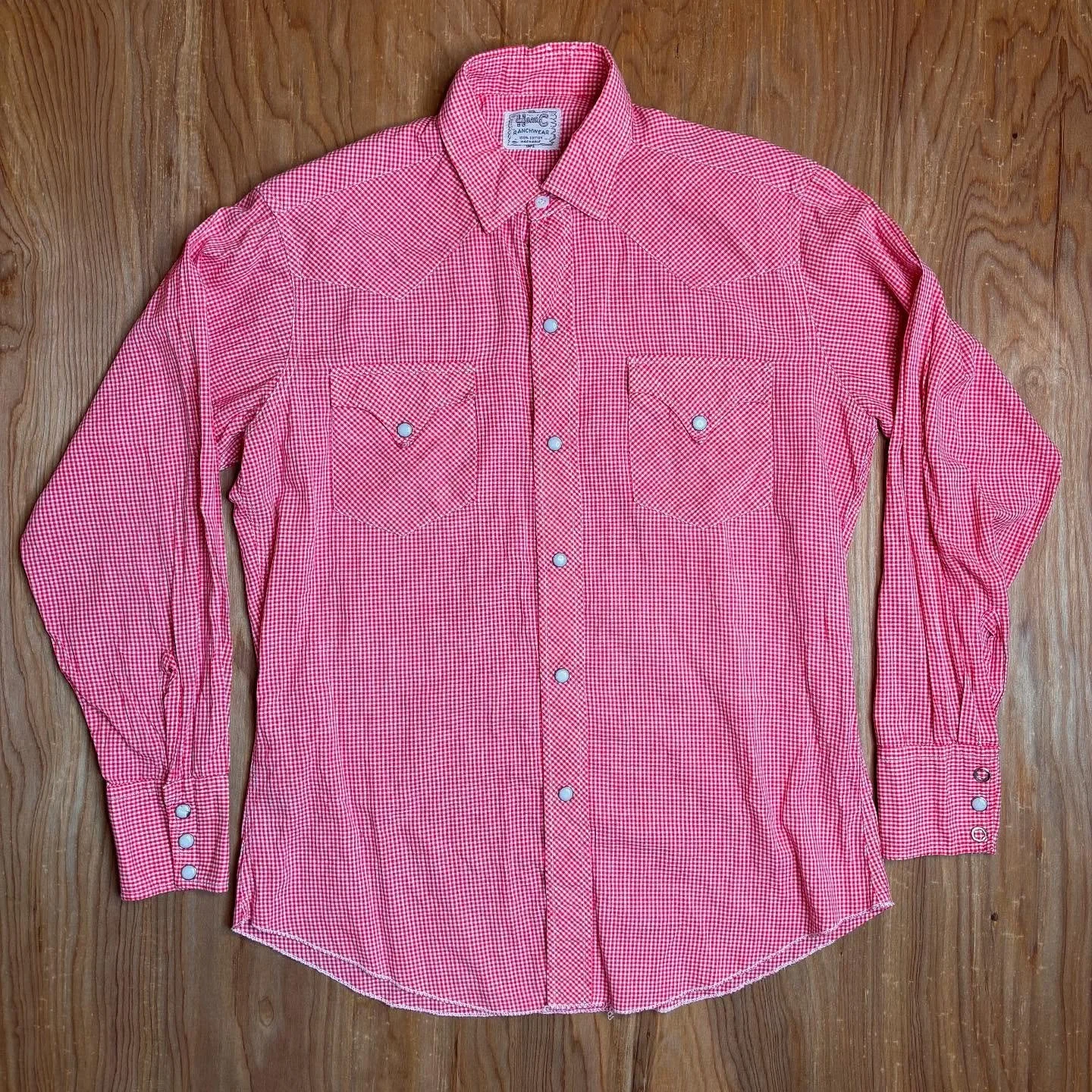 A shirt for barn dances, jukebox dives, and sweet summertime mischief. This vintage H Bar C number is cut from a red gingham that&rsquo;s equal parts cowboy charm and rockabilly grit. Detailed with pearl snaps and pointed yokes, it&rsquo;s the kind o