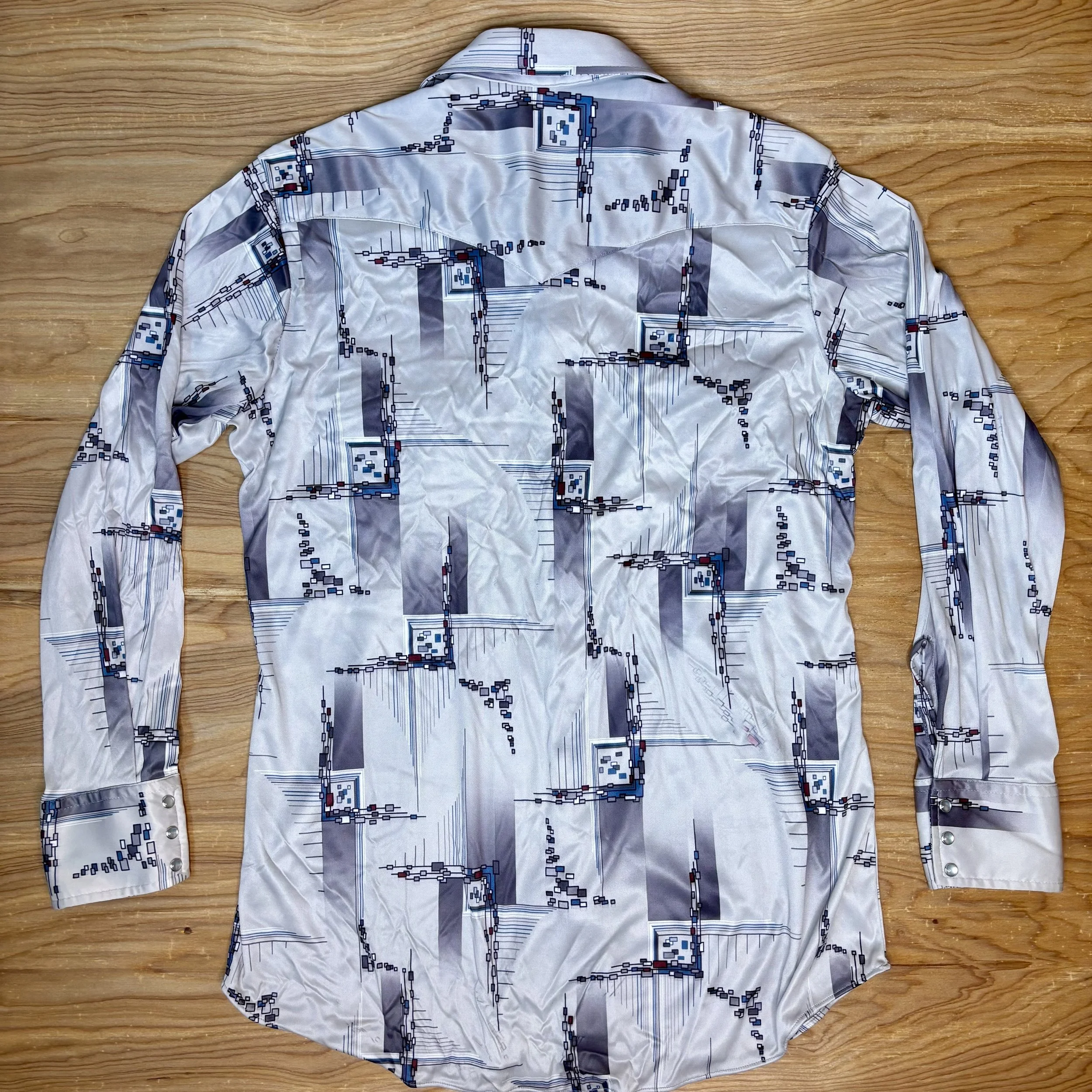 Back view of vintage satin pearl snap shirt with atomic-style pattern