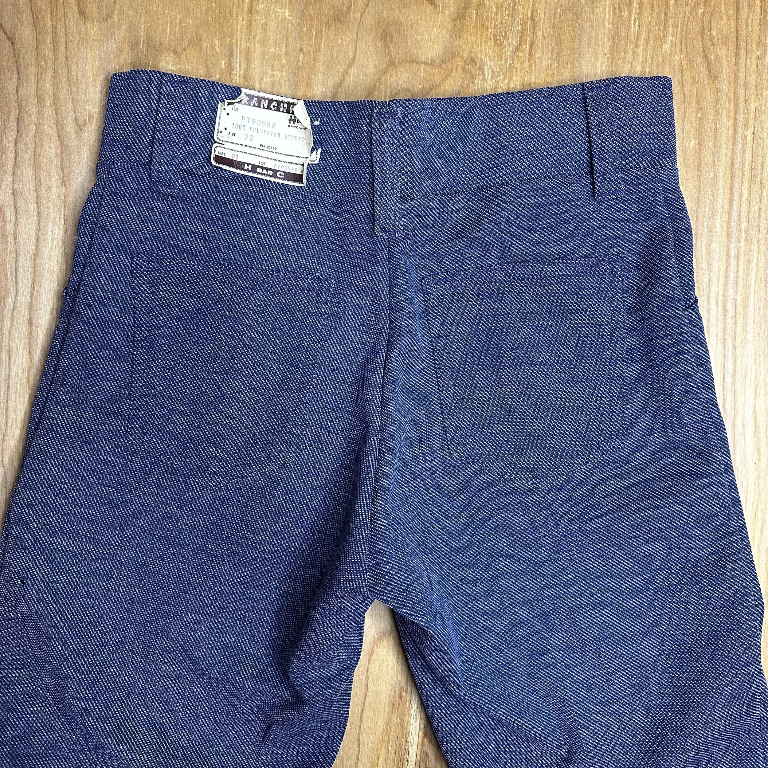 Back view of the pants with a tiny, perfectly round hole, adding character to the vintage piece.