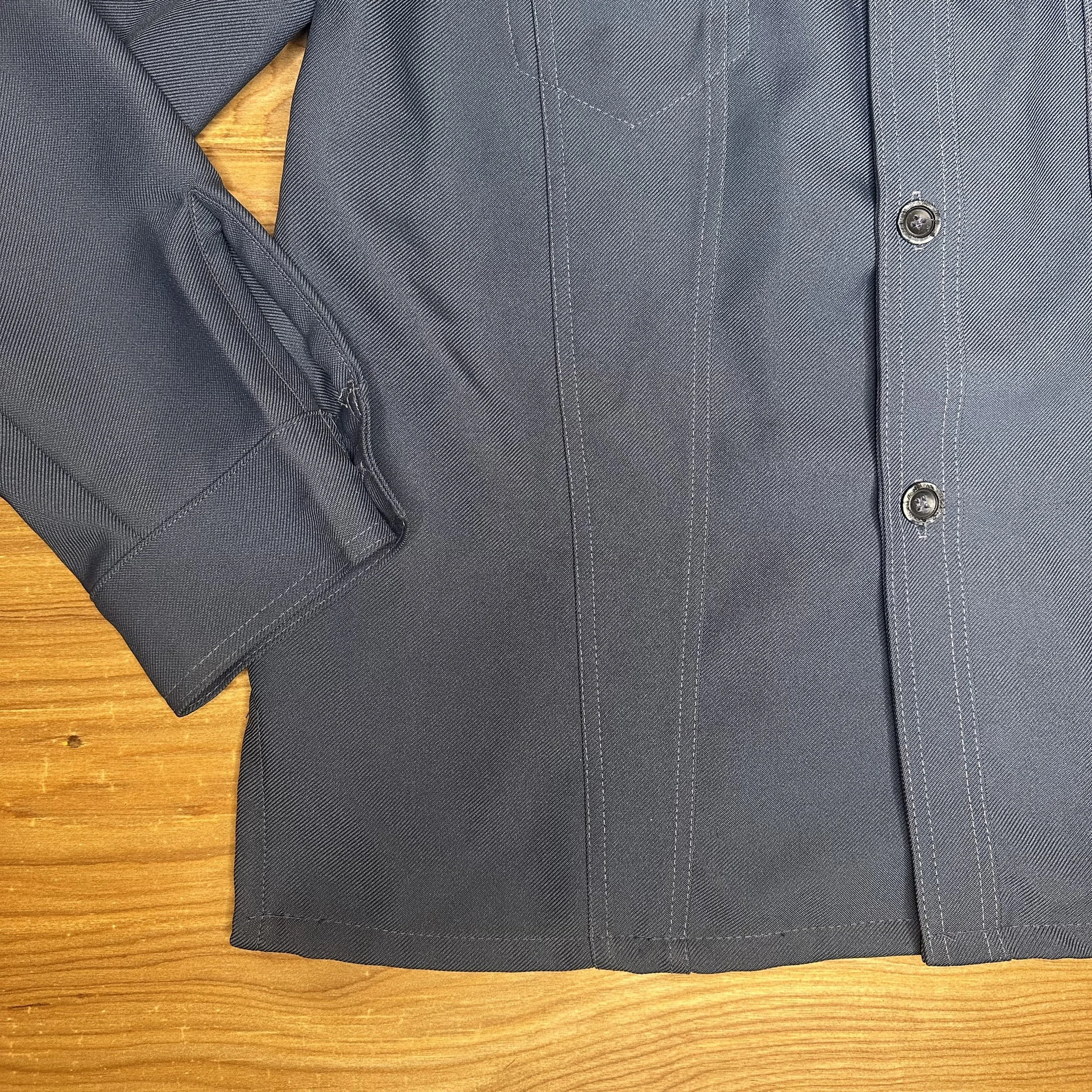 Close-up of sleeve and hem on vintage Levi’s chore coat-style shacket, showing stitching detail and fabric texture.