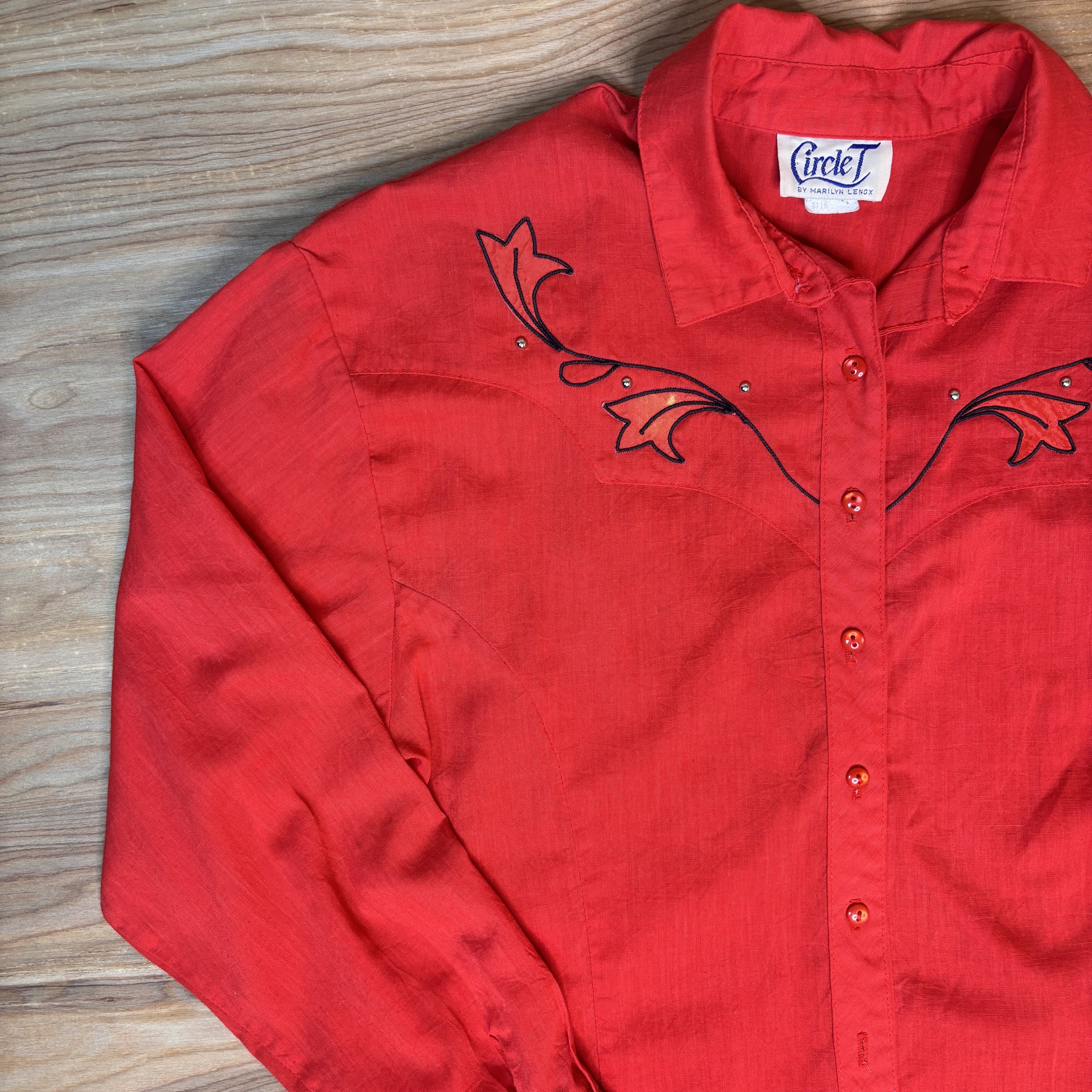 Side angle showing sleeve and bodice structure of red western shirt