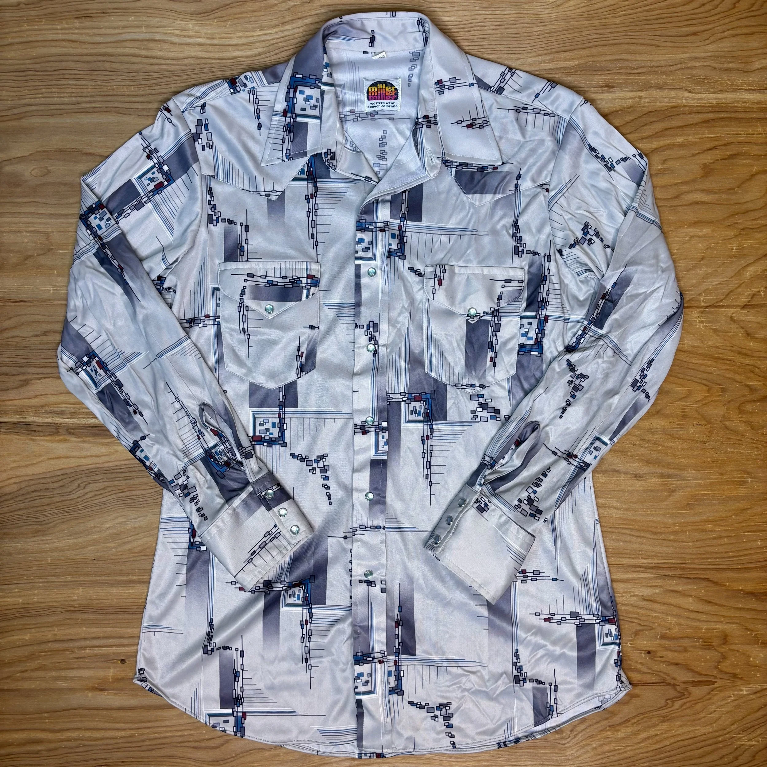 Front view of vintage Miller satin pearl snap shirt with geometric mid-century modern print