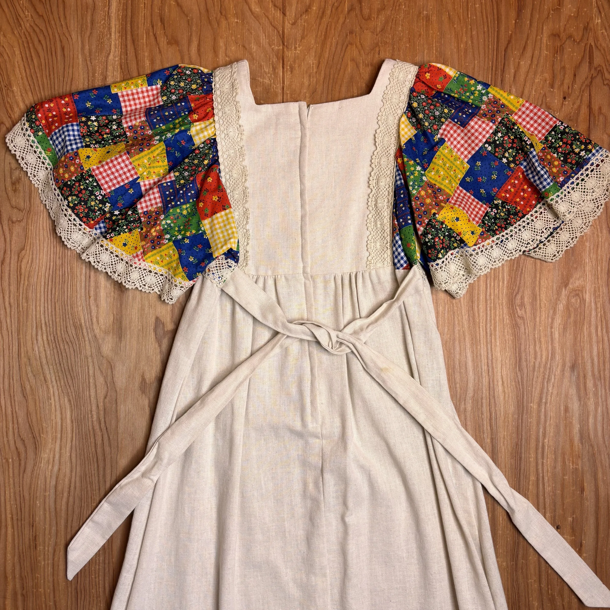 Back view showing waist ties and sleeve detail