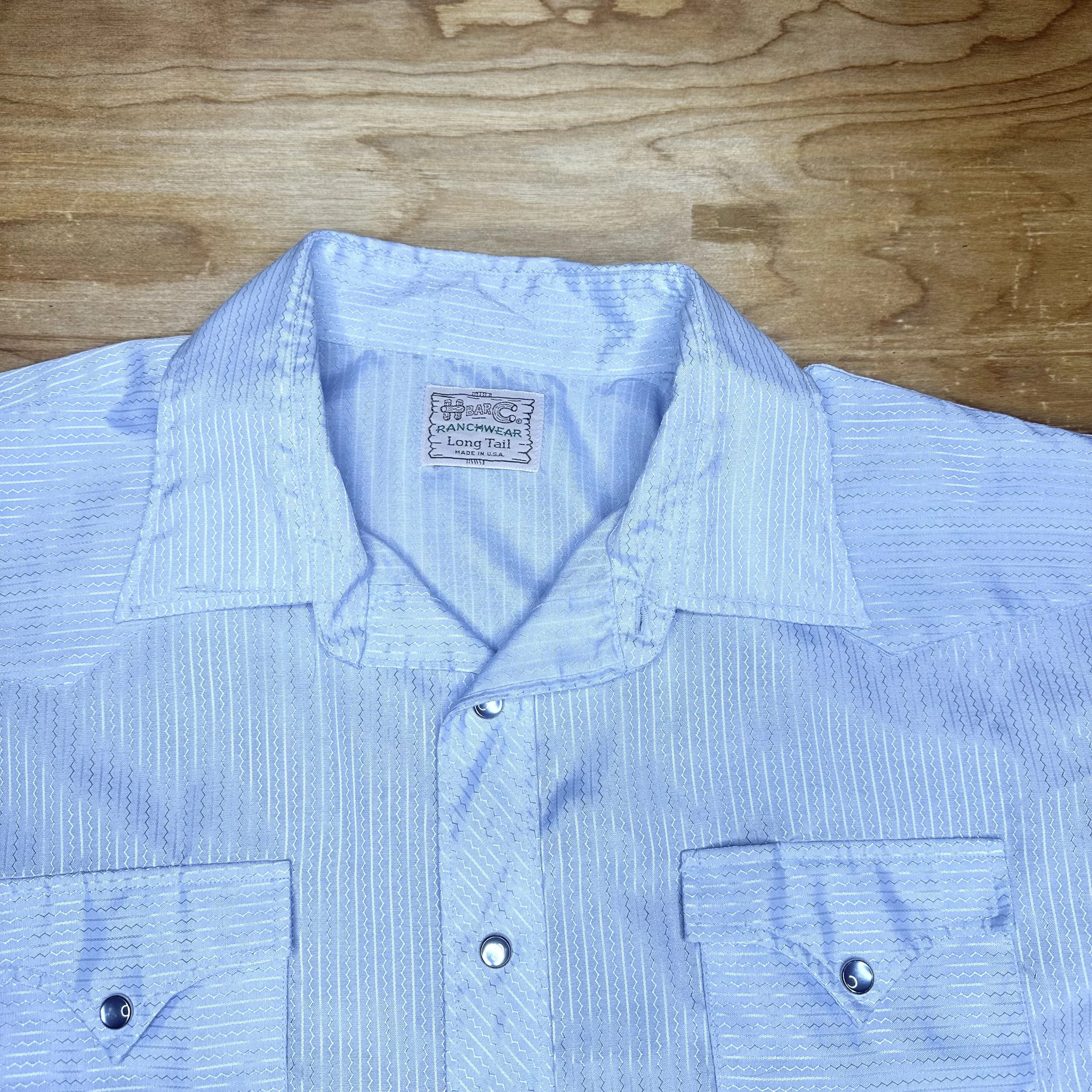Detail of double chest pockets with snap closures on H Bar C pearl snap.