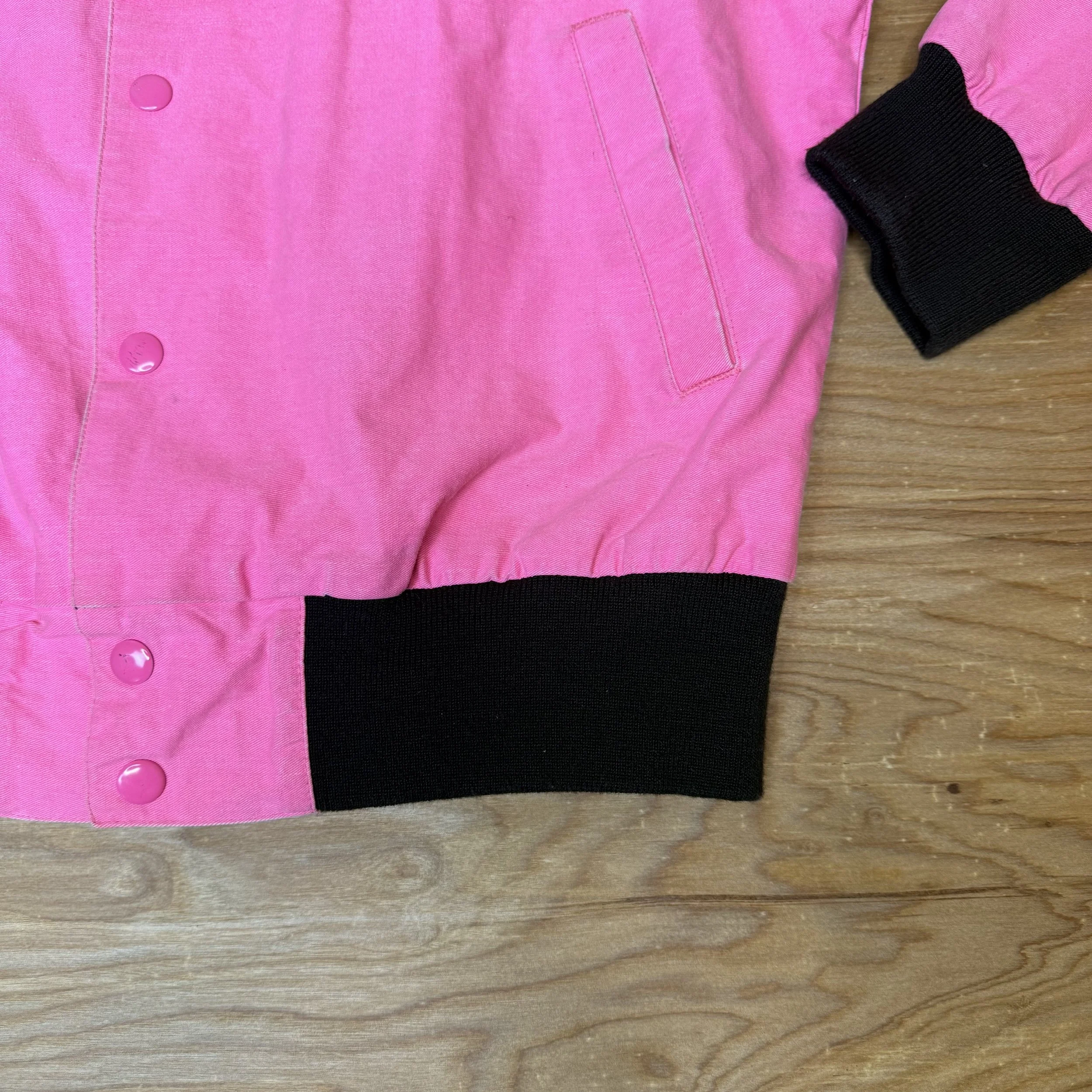 Close-up of ribbed black hem and cuff on Wrangler Brushpopper jacket with snap button details.